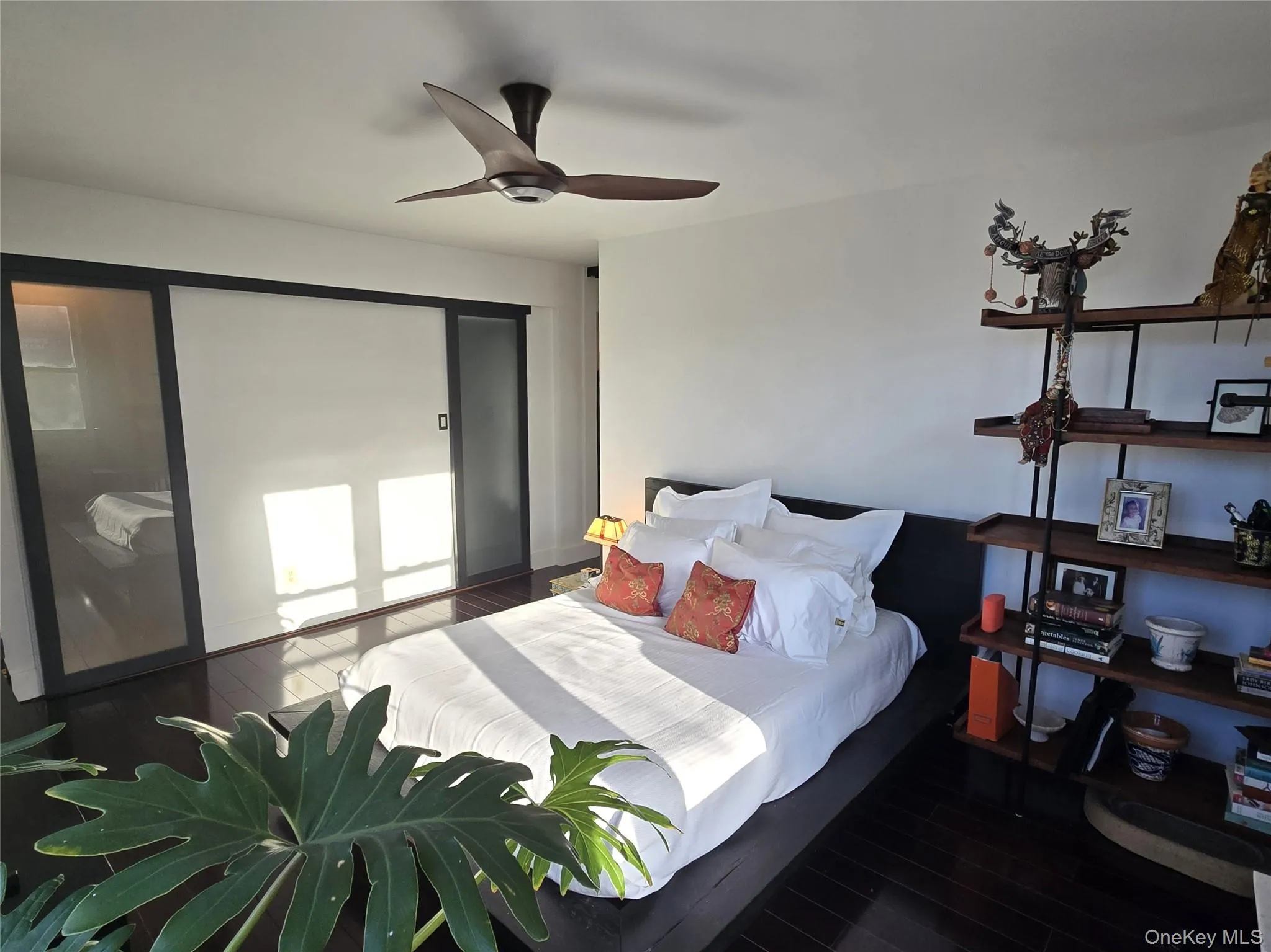 Primary bedroom with sliding suspended doors Primary bedroom with sliding suspended doors