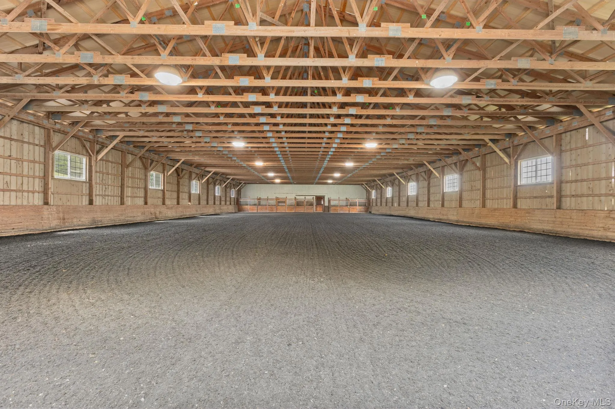 72x160 indoor riding ring connected to the barn with new footing, a new roof and new LED lighting 72x160 indoor riding ring connected to the barn with new footing, a new roof and new LED lighting