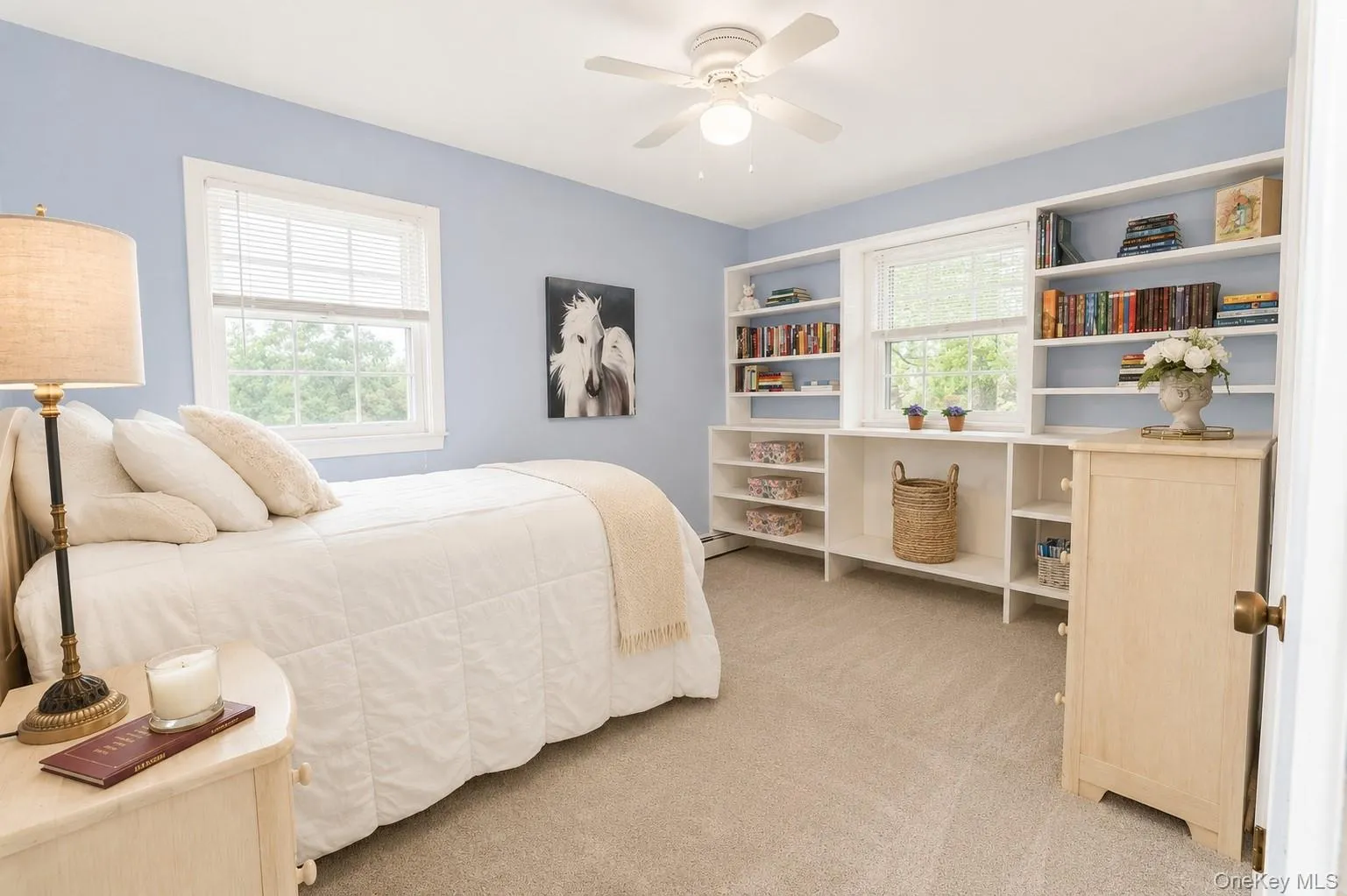 This large bedroom features double windows and soft carpeting, with hardwood flooring hidden underneath for added charm and potential. This large bedroom features double windows and soft carpeting, with hardwood flooring hidden underneath for added charm and potential.