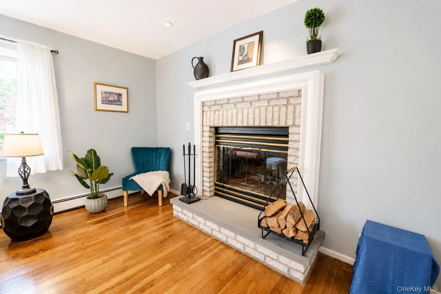 Anchoring the space is a stunning wood-burning fireplace featuring a beautifully crafted mantel that adds warmth and timeless character. Anchoring the space is a stunning wood-burning fireplace featuring a beautifully crafted mantel that adds warmth and timeless character.