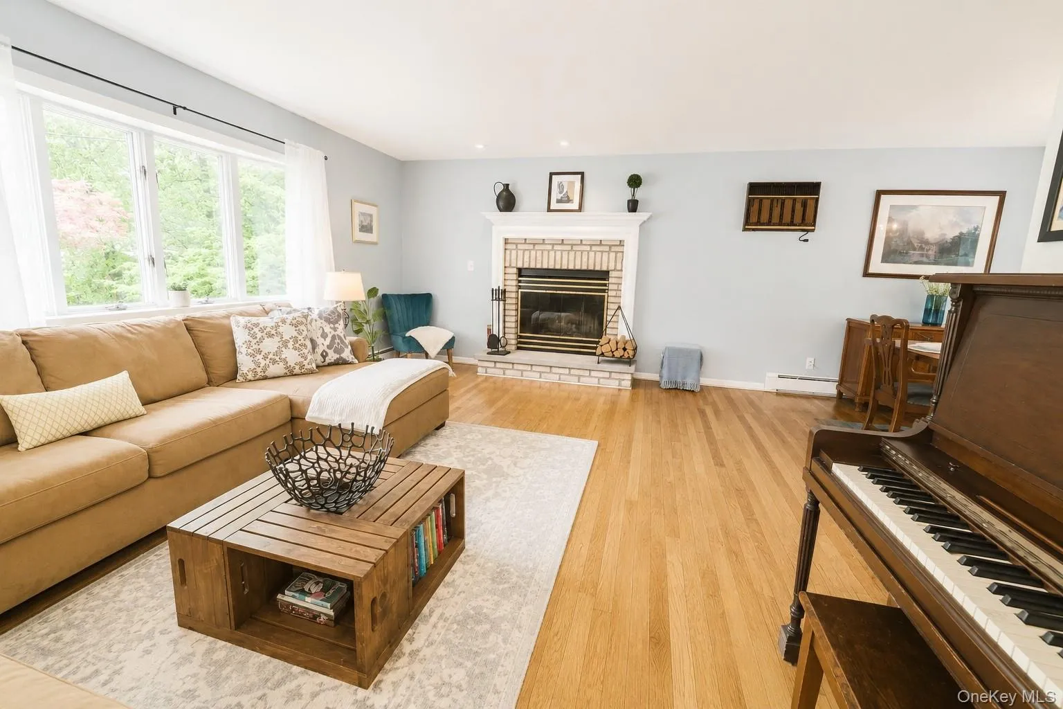 Enjoy this spacious living room offering gleaming hardwood floors and a large bay window that welcomes an abundance of natural light. Enjoy this spacious living room offering gleaming hardwood floors and a large bay window that welcomes an abundance of natural light.
