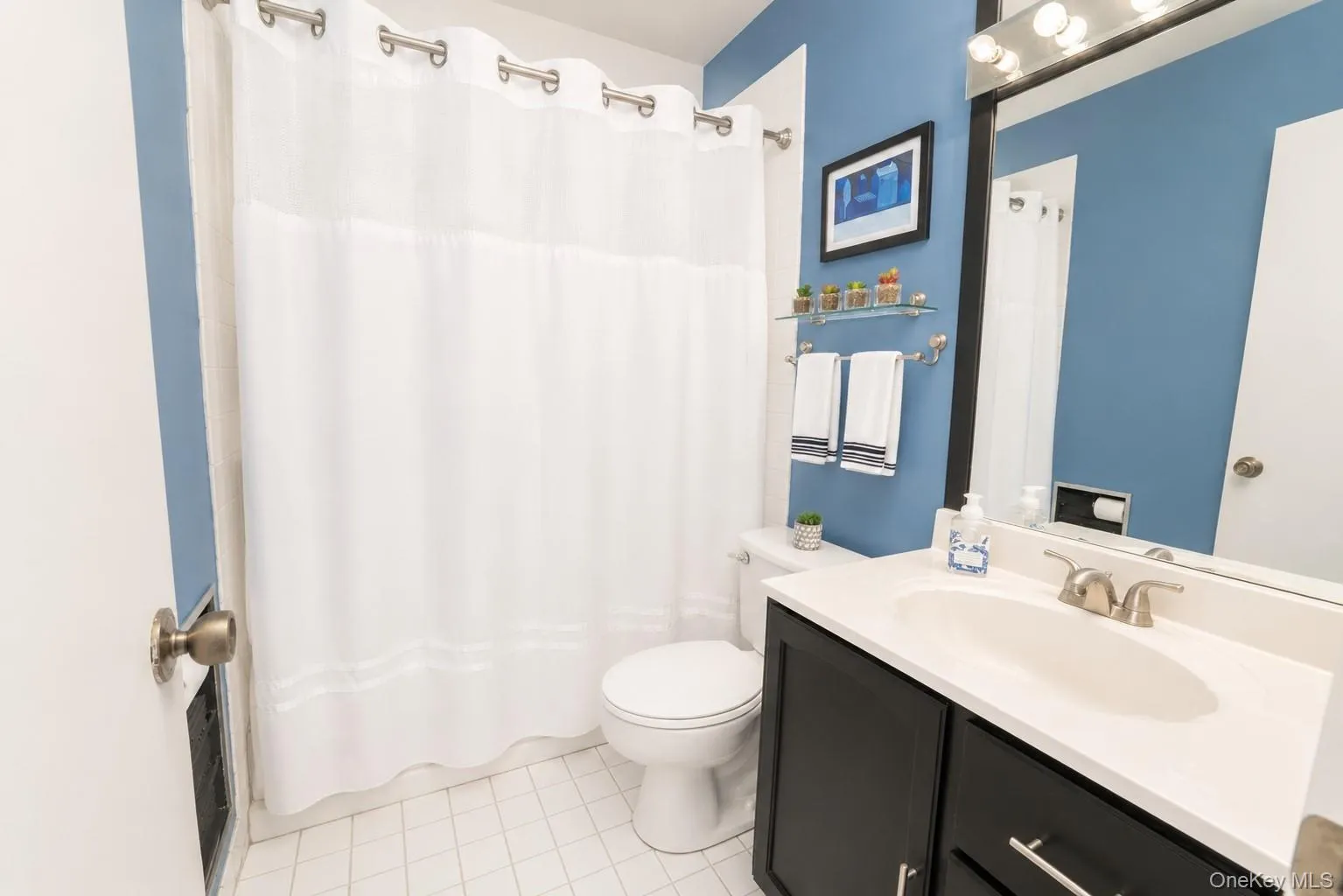 Main floor hallway bathroom offering a full tub and a functional, well-appointed layout. Main floor hallway bathroom offering a full tub and a functional, well-appointed layout.
