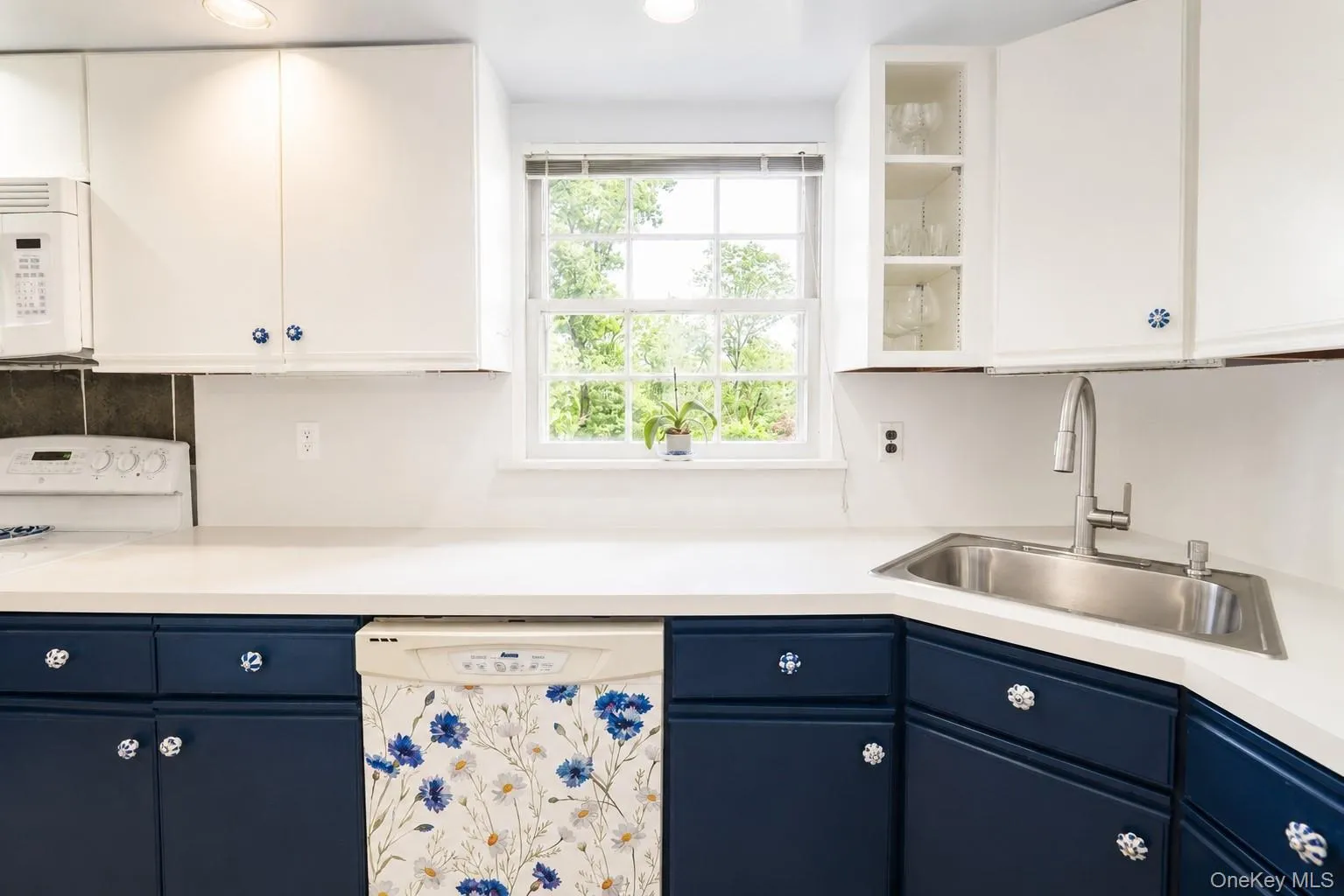 Another view of this bright kitchen featuring a window that fills the space with beautiful natural light. Another view of this bright kitchen featuring a window that fills the space with beautiful natural light.