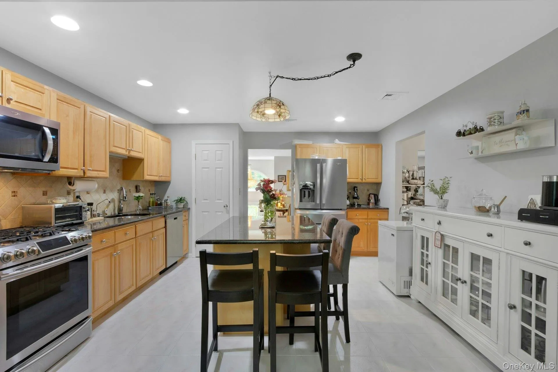 Kitchen with movable island, stainless appliances, recessed lighting Kitchen with movable island, stainless appliances, recessed lighting