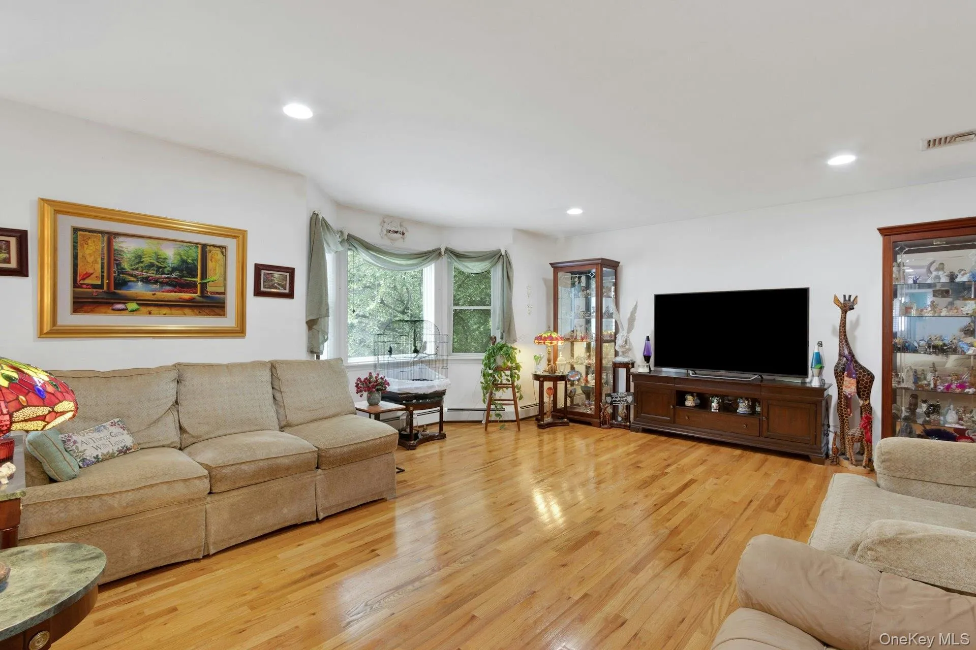 Living room with hardwood floors, recessed lighting, sunlight Living room with hardwood floors, recessed lighting, sunlight