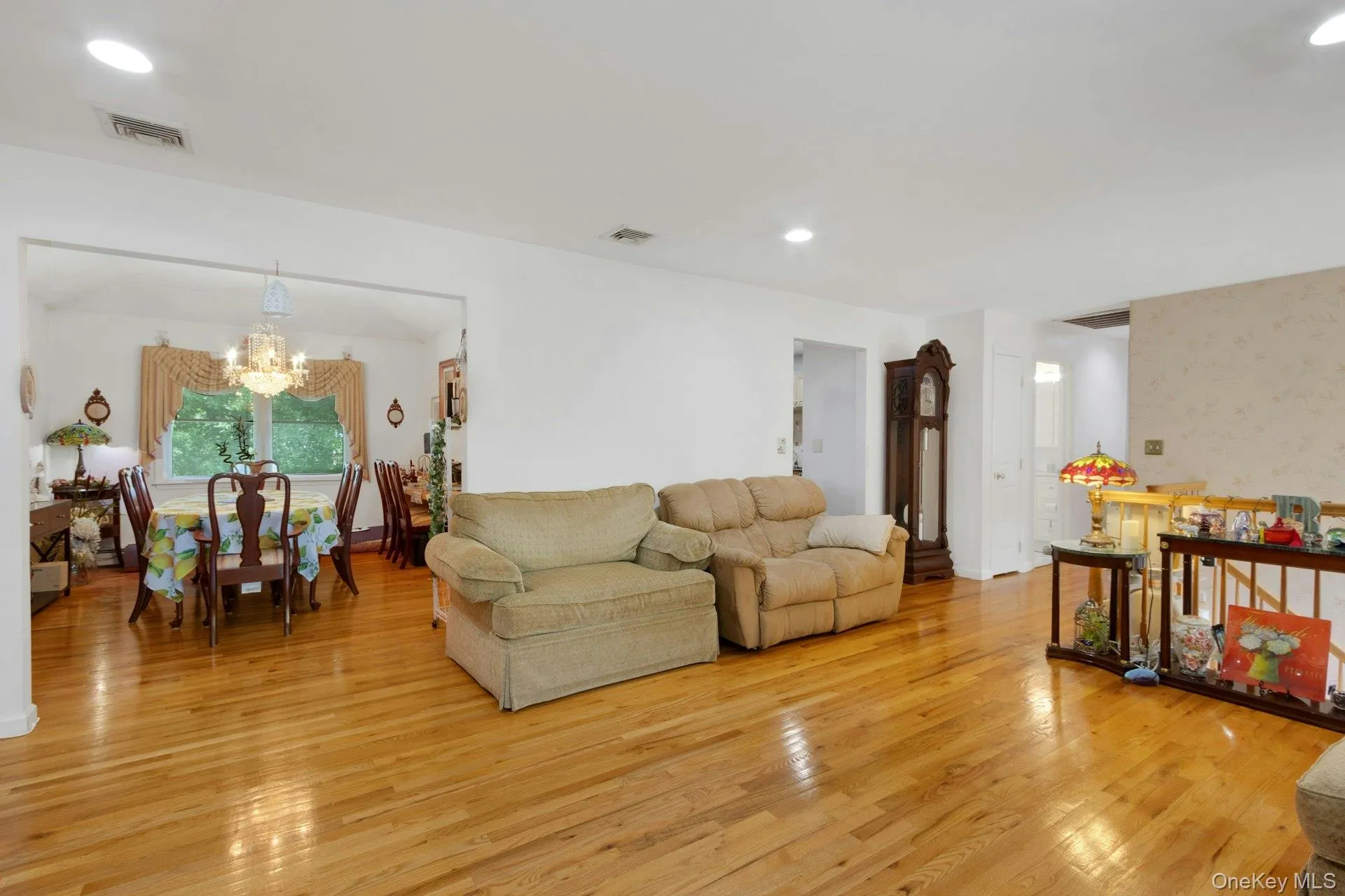 Living room open layout to dining room, hardwood floors, recessed lighting, sunlight Living room open layout to dining room, hardwood floors, recessed lighting, sunlight