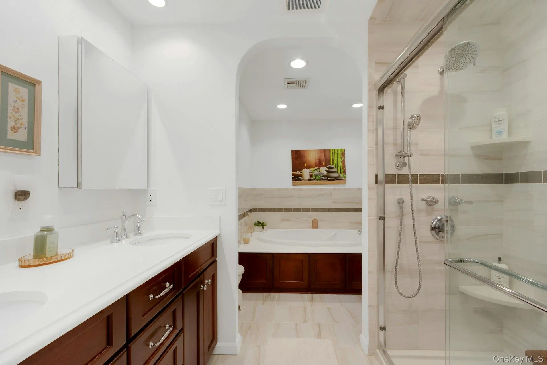 Luxurious updated ensuite bathroom with a double vanity, walk-in shower, large jacuzzi soaking tub Luxurious updated ensuite bathroom with a double vanity, walk-in shower, large jacuzzi soaking tub
