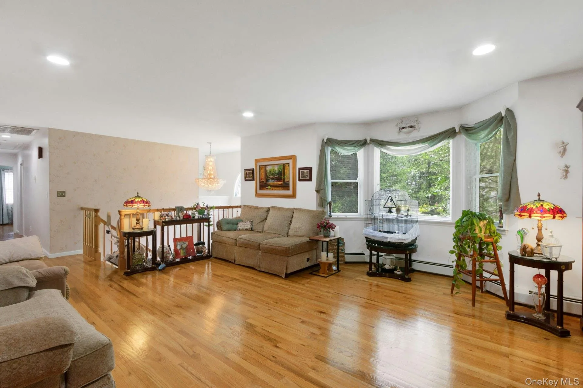 Living room with hardwood floors, recessed lighting, sunlight Living room with hardwood floors, recessed lighting, sunlight