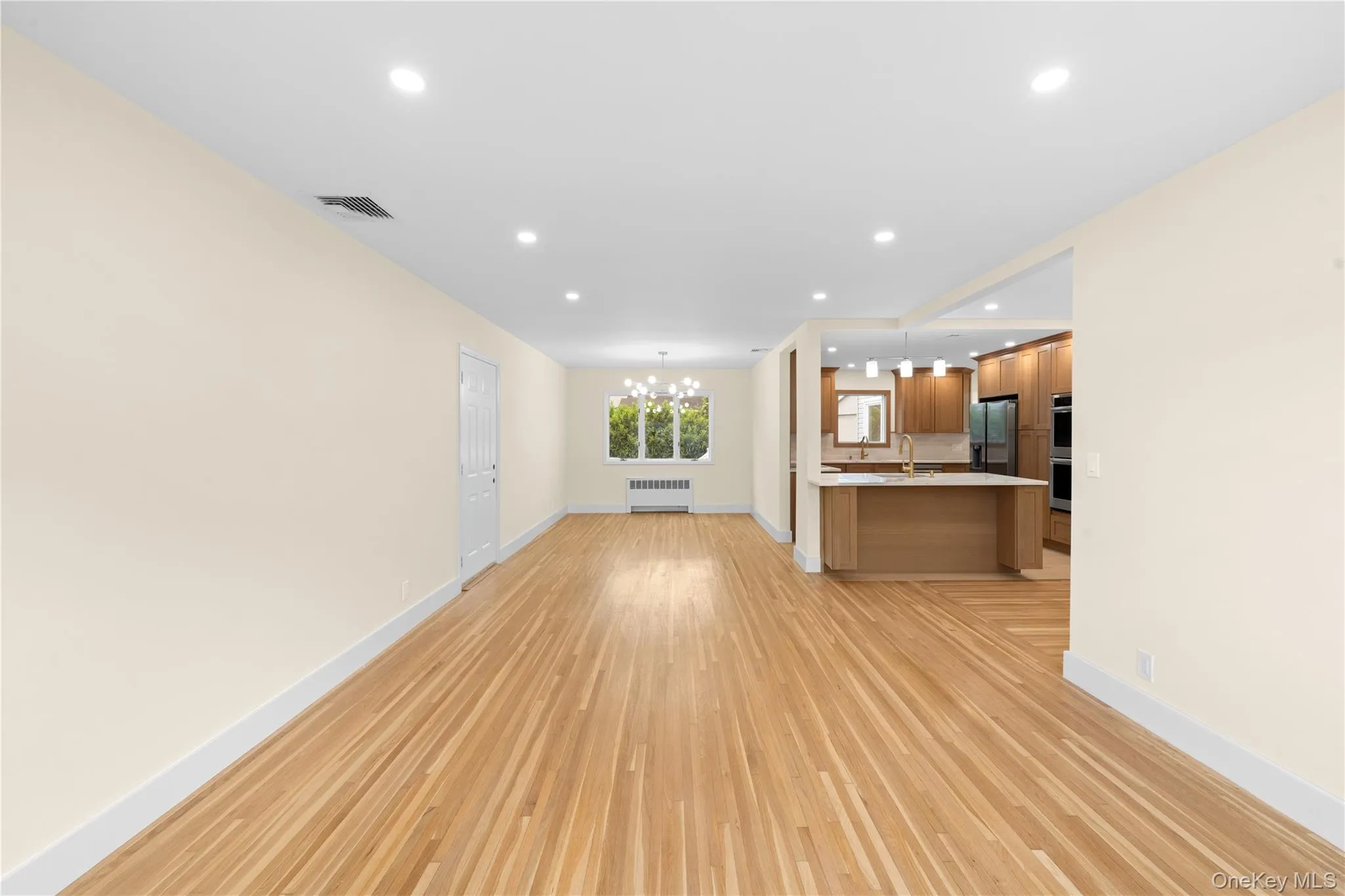 FORMAL LIVING ROOM OPEN TO THE DINING ROOM AND KITCHEN FORMAL LIVING ROOM OPEN TO THE DINING ROOM AND KITCHEN