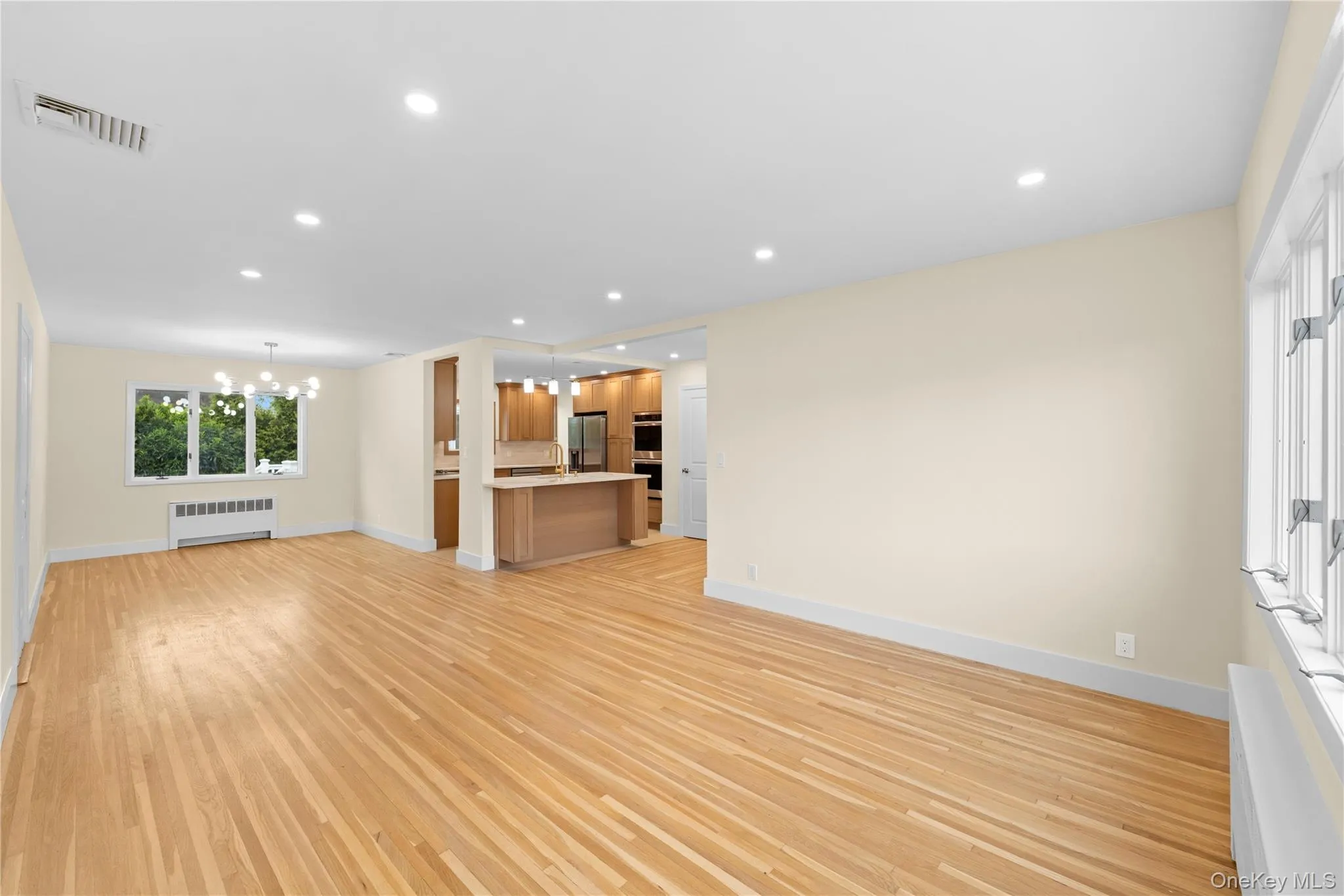 FORMAL LIVING ROOM OPEN TO THE DINING ROOM AND KITCHEN FORMAL LIVING ROOM OPEN TO THE DINING ROOM AND KITCHEN