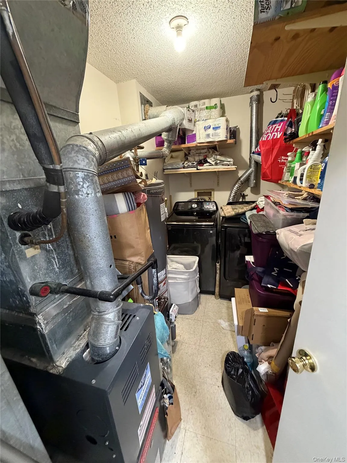 Utility room featuring a built-in furnace, washer, and dryer units Utility room featuring a built-in furnace, washer, and dryer units