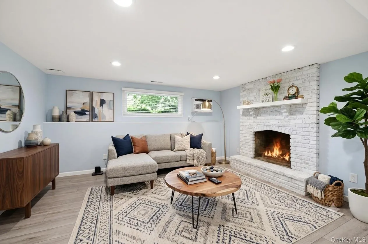 Virtually staged lower level living room, wood burning fireplace Virtually staged lower level living room, wood burning fireplace