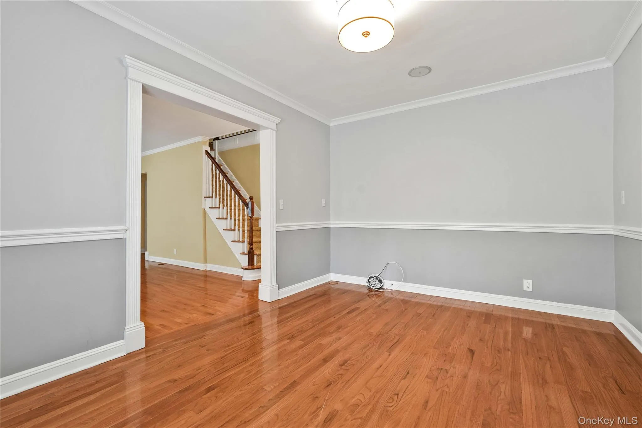 Hardwood flooring complemented by chair rail molding and crown molding Hardwood flooring complemented by chair rail molding and crown molding