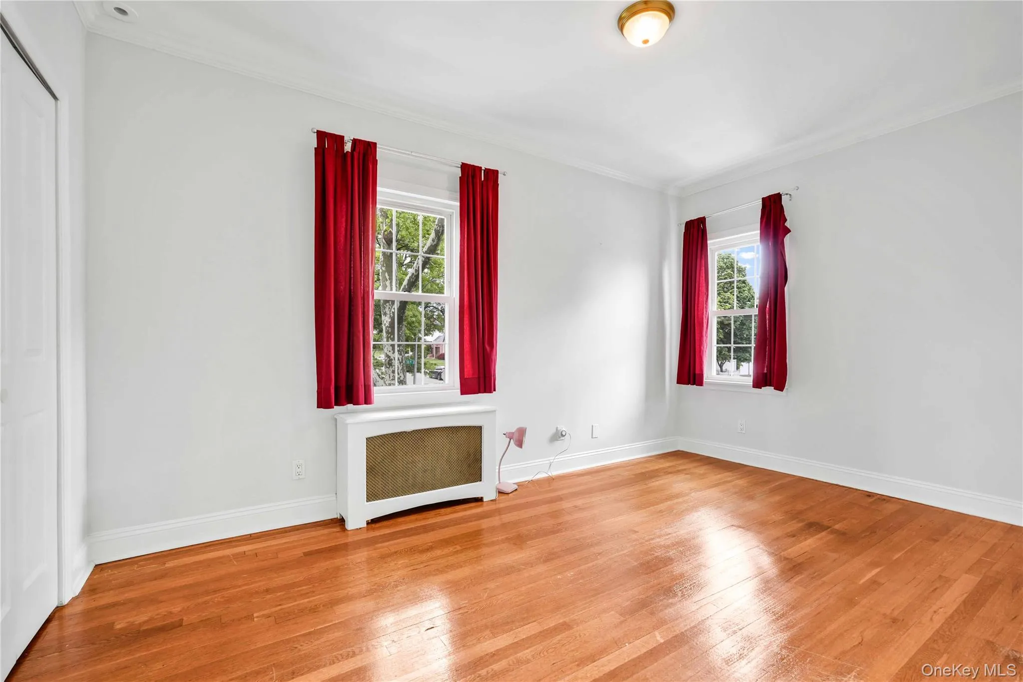 Bedroom 3Bright interior space featuring wood-finish flooring, white walls, and two windows Bedroom 3Bright interior space featuring wood-finish flooring, white walls, and two windows