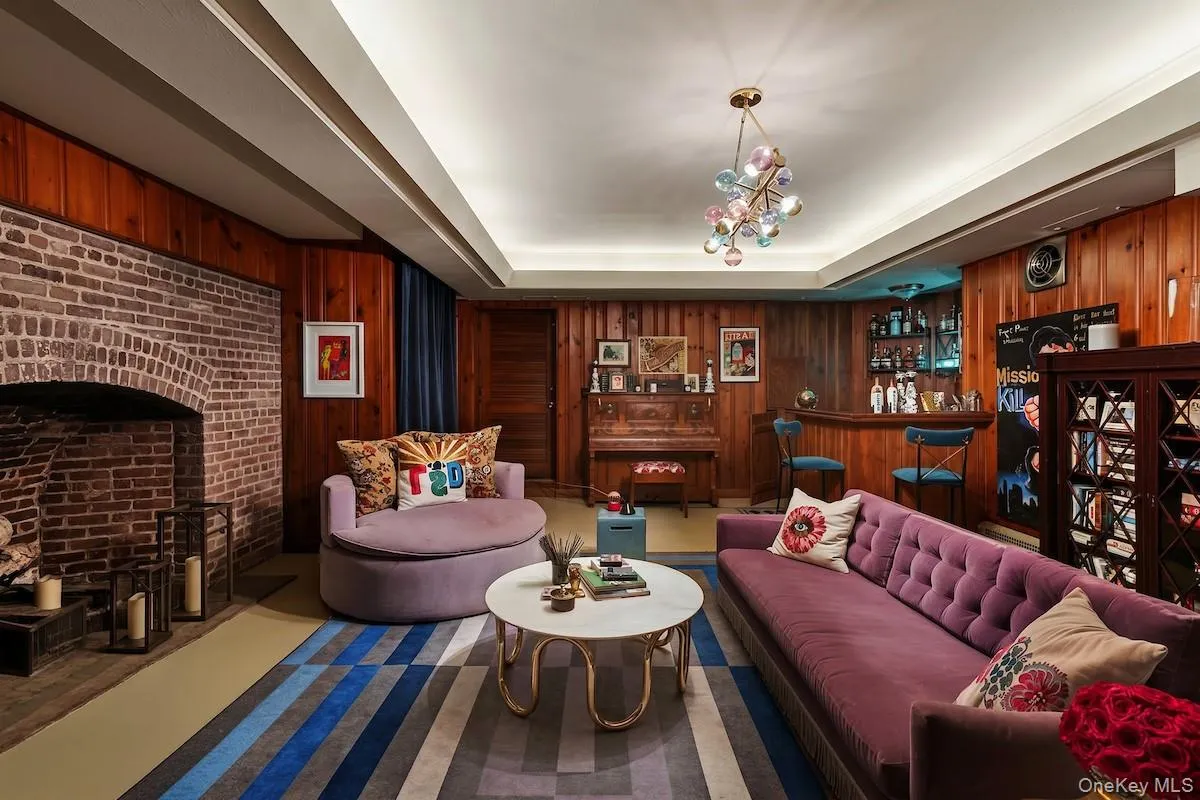 Lower level family room with brick arched fireplace and bar reminiscent of a speakeasy! Lower level family room with brick arched fireplace and bar reminiscent of a speakeasy!