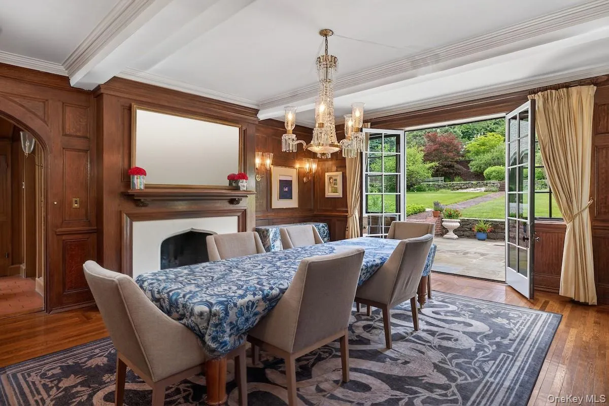 Dining Room with rich oak paneling with French doors leading to entertainment terrace Dining Room with rich oak paneling with French doors leading to entertainment terrace