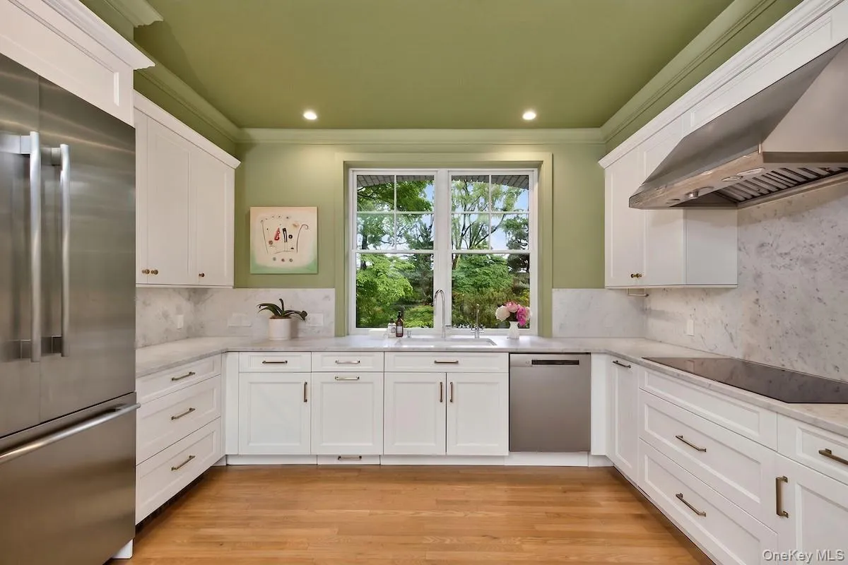 Kitchen with marble counter surfaces and ample shaker-style cabinetry Kitchen with marble counter surfaces and ample shaker-style cabinetry
