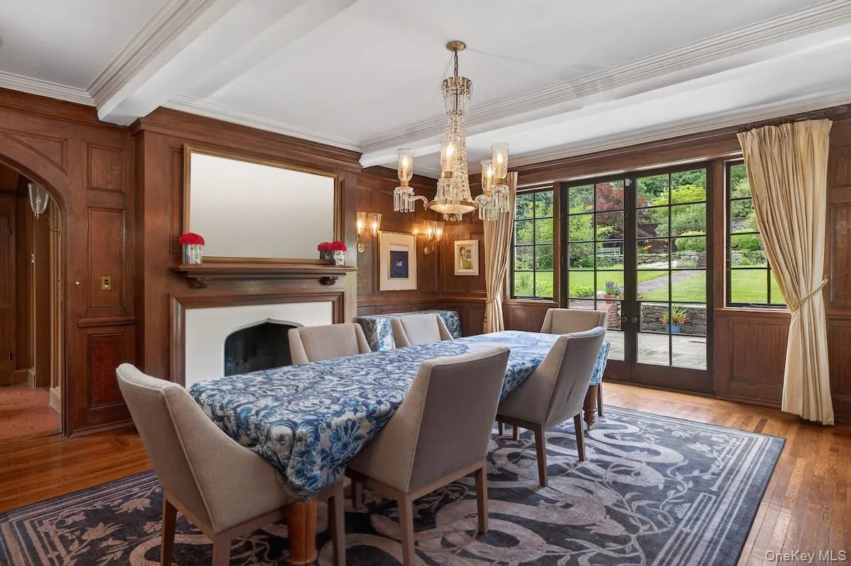 Inviting dining room with wood-burning fireplace and oak-paneled walls Inviting dining room with wood-burning fireplace and oak-paneled walls