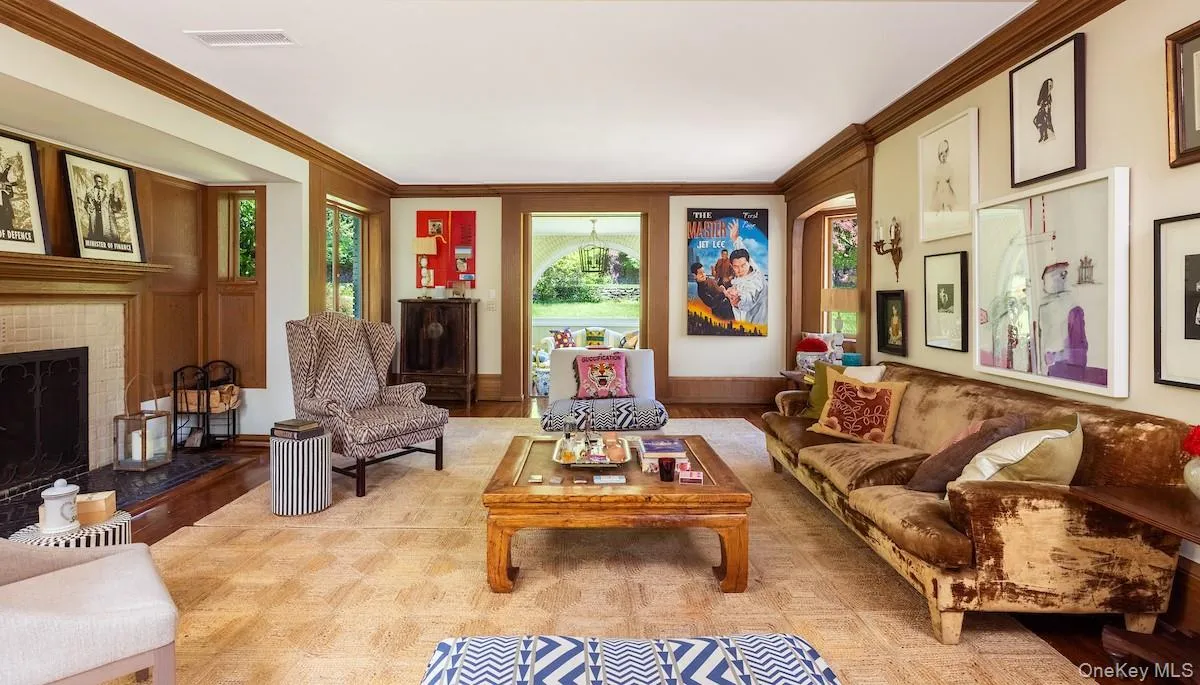 Living room with matching casement windows, crown moldings and oak floors Living room with matching casement windows, crown moldings and oak floors