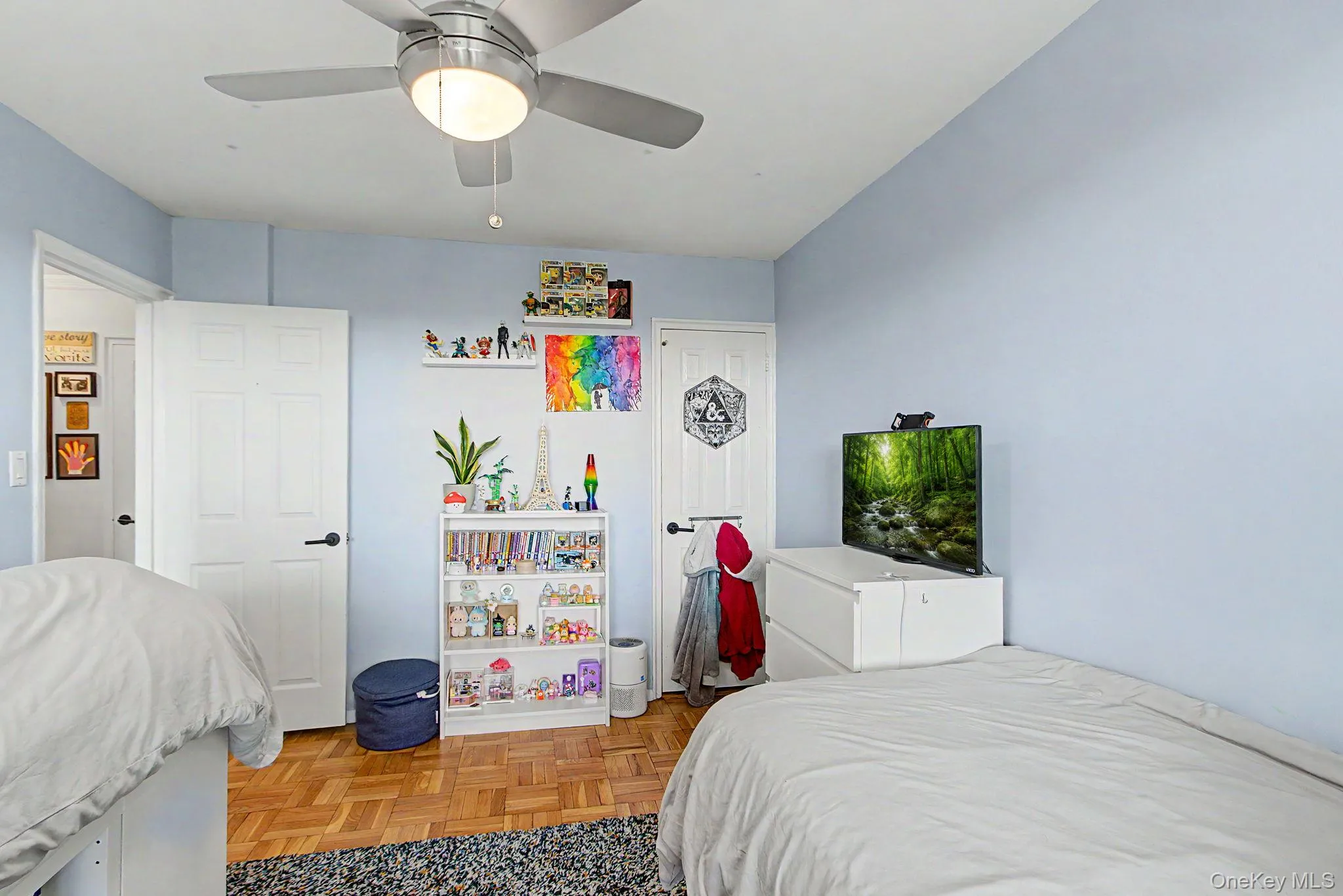 Room with light blue walls and wood-finish parquet flooring Room with light blue walls and wood-finish parquet flooring