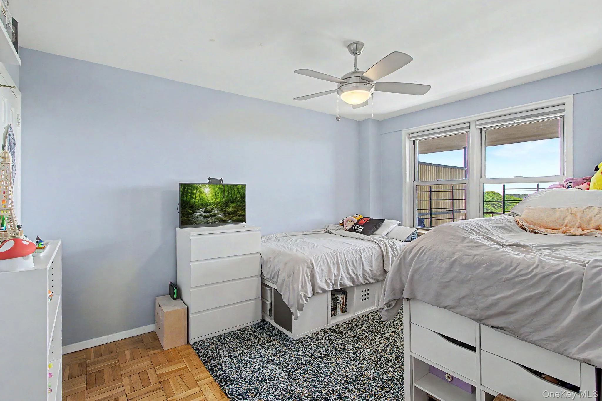 Room featuring light blue walls and a full-light window Room featuring light blue walls and a full-light window