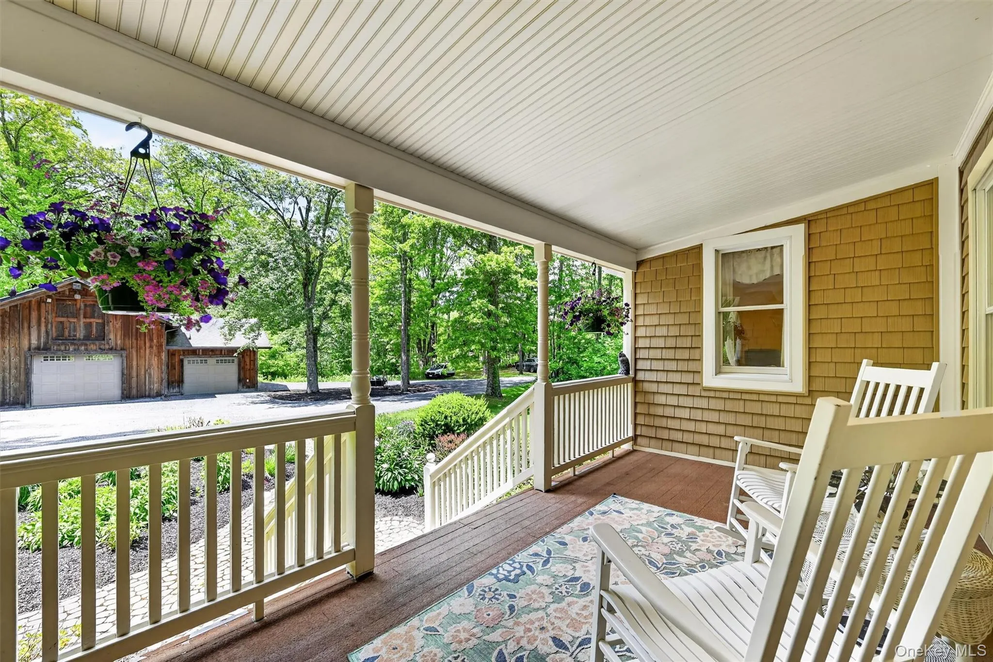 Covered wood porch with white railing Covered wood porch with white railing