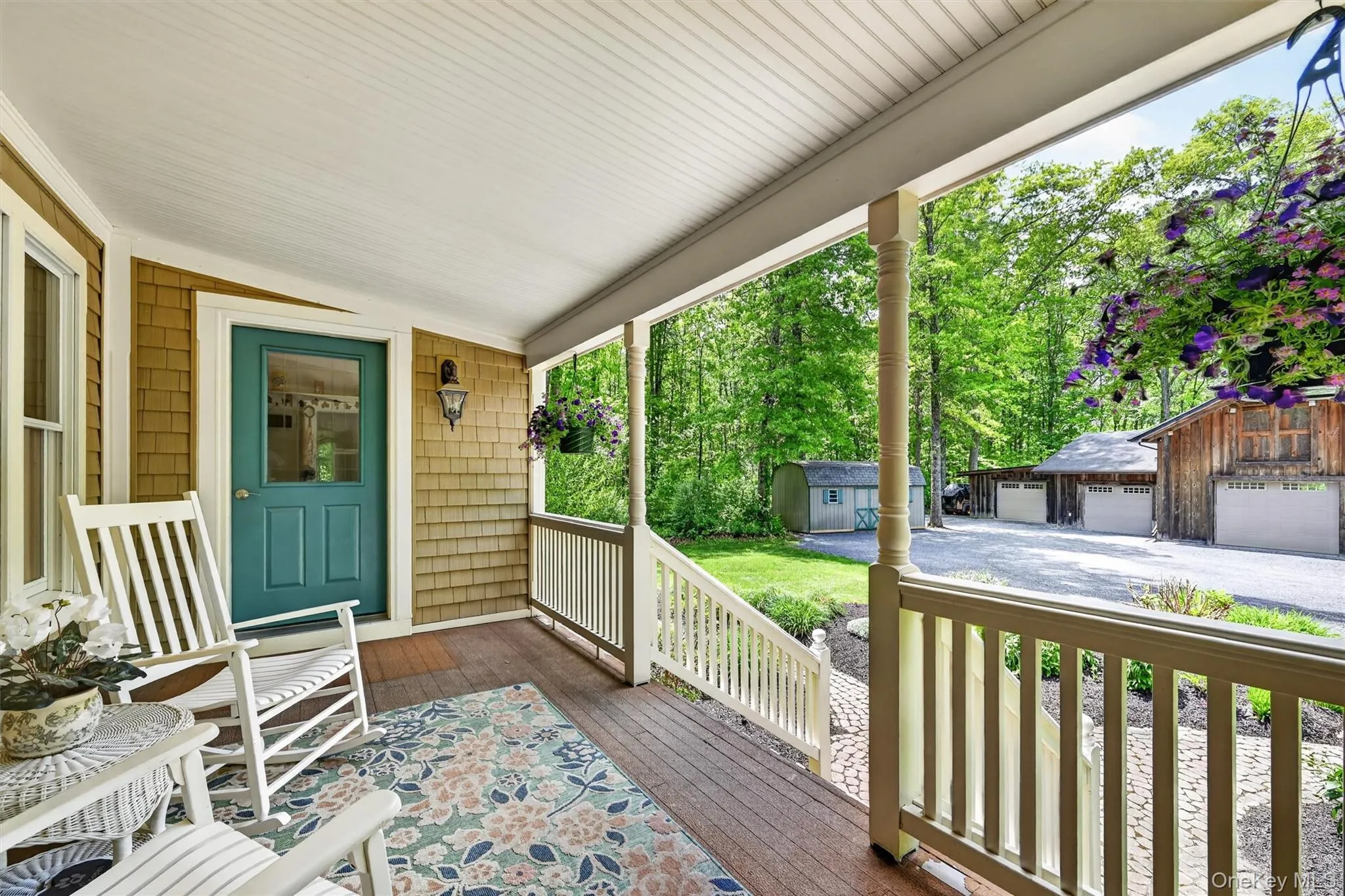 Inviting covered porch with wood-finish flooring and a beadboard ceiling Inviting covered porch with wood-finish flooring and a beadboard ceiling