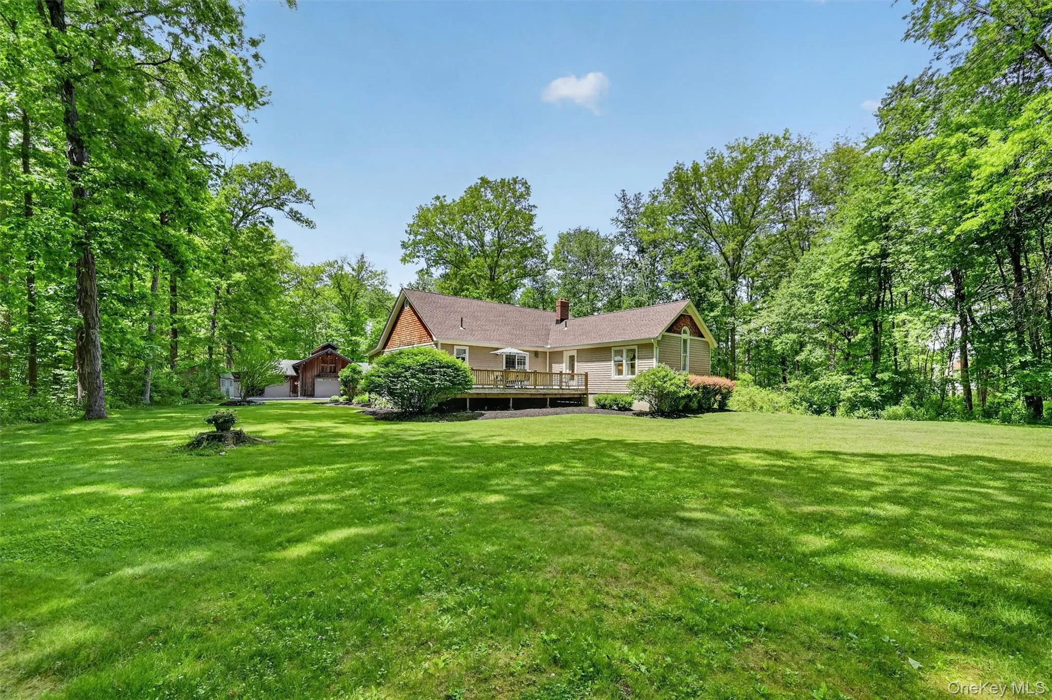 Expansive, level lawn surrounded by mature trees, offering a private outdoor setting with a spacious deck and peaceful wooded backdrop. Expansive, level lawn surrounded by mature trees, offering a private outdoor setting with a spacious deck and peaceful wooded backdrop.