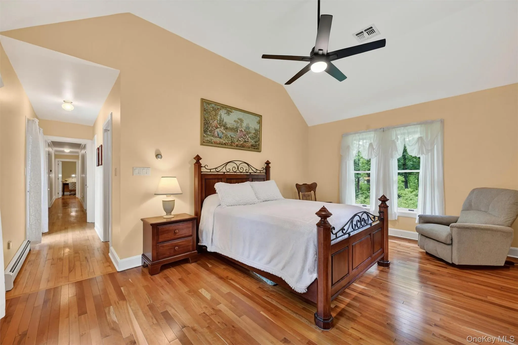 Hardwood flooring extending into a hallway with recessed lighting Hardwood flooring extending into a hallway with recessed lighting