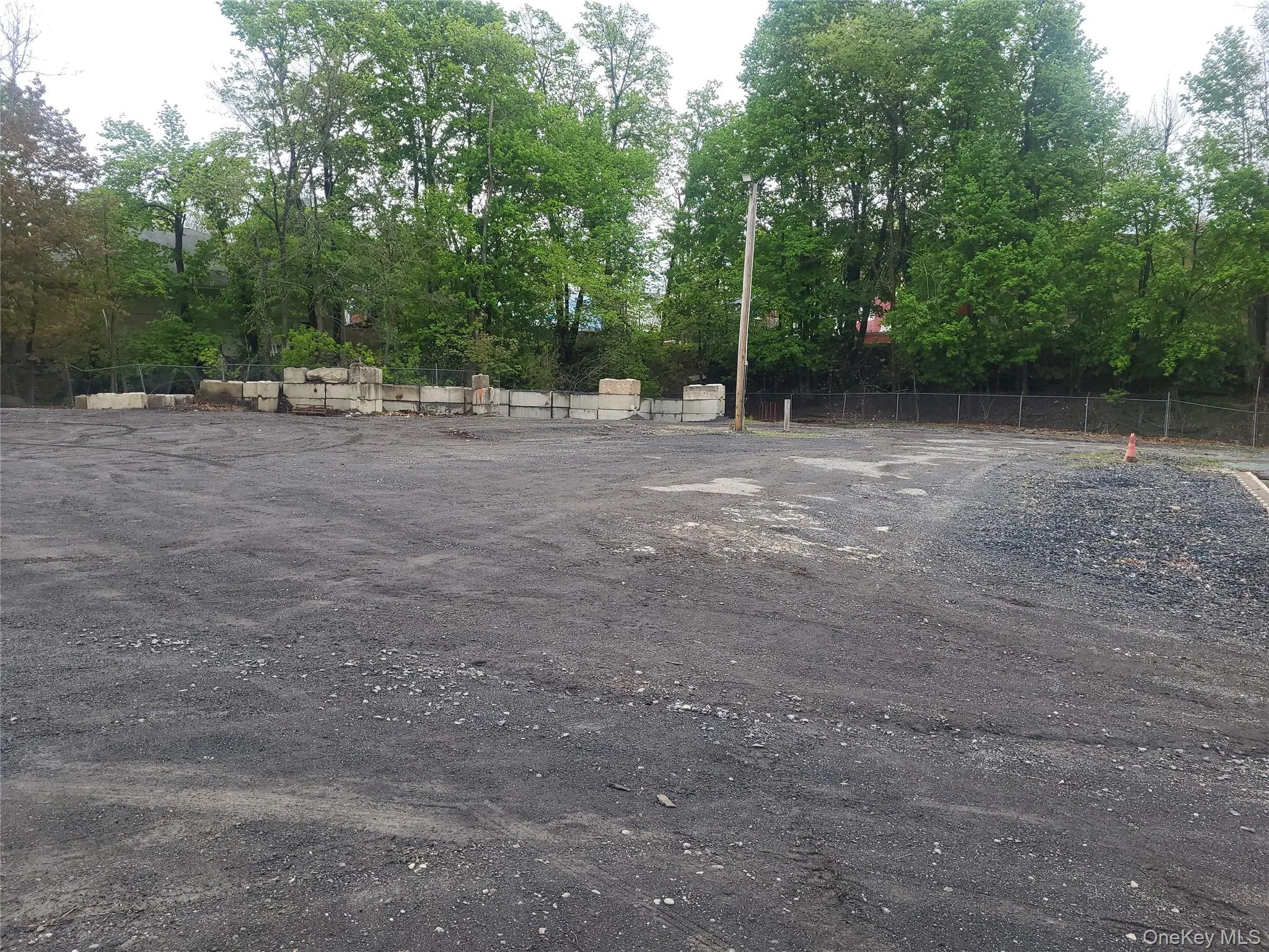 current photo of the fenced industrial lot current photo of the fenced industrial lot