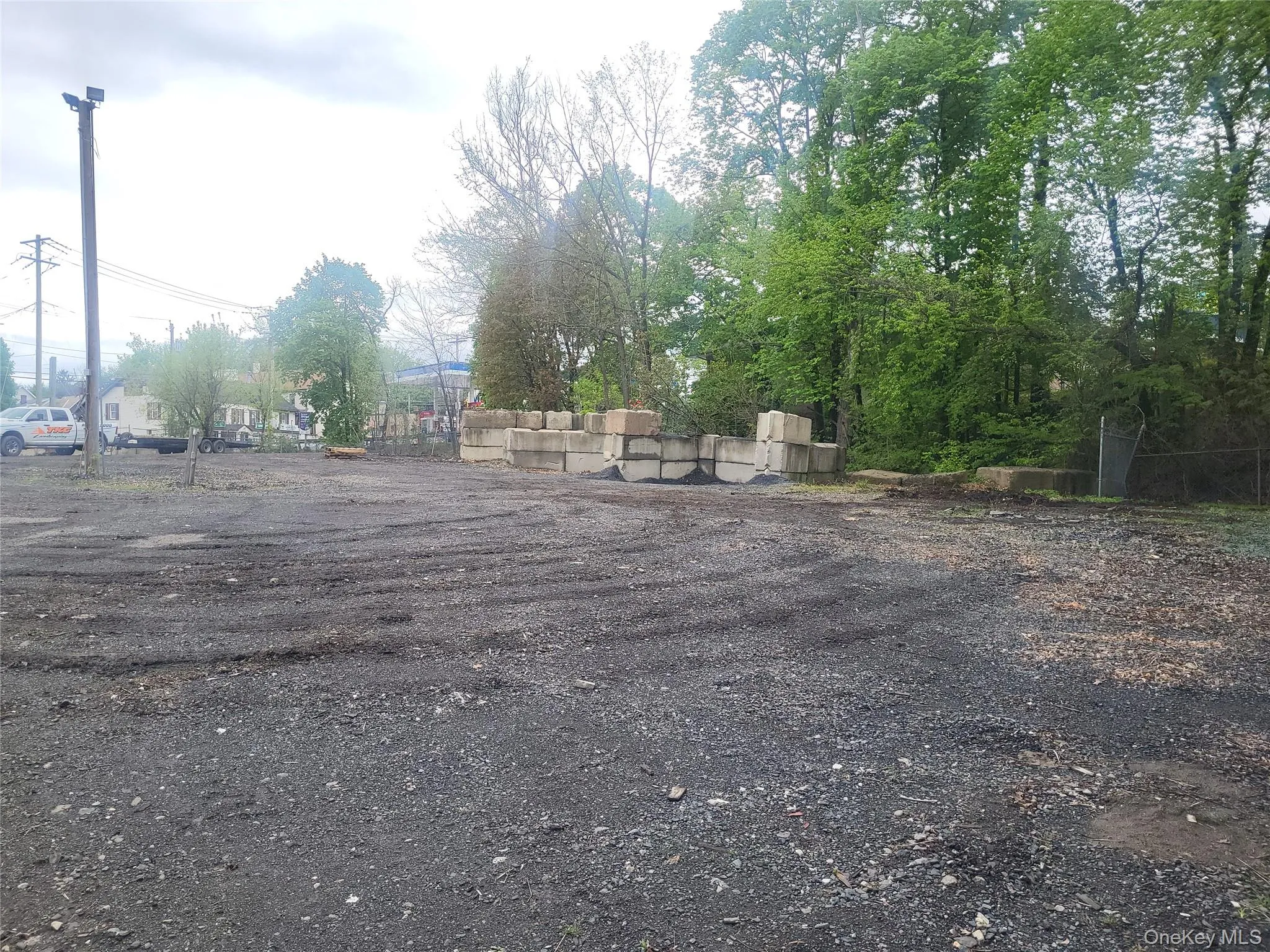current photo of the fenced industrial lot current photo of the fenced industrial lot
