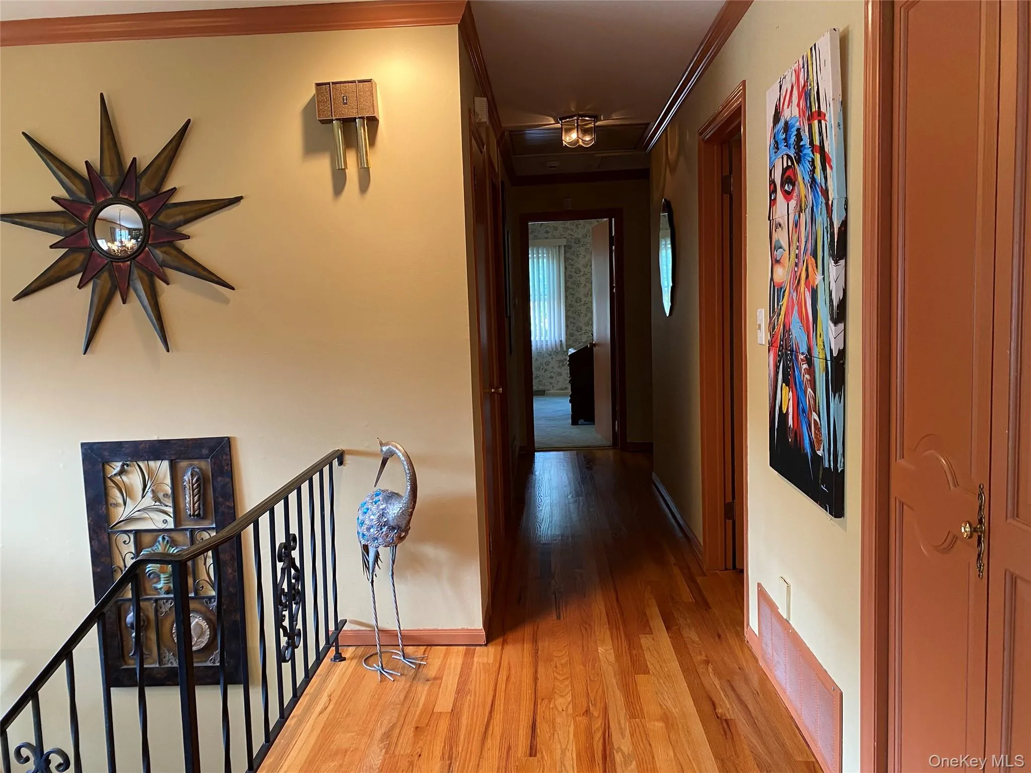Hallway featuring crown molding and light hardwood / wood-style floors Hallway featuring crown molding and light hardwood / wood-style floors
