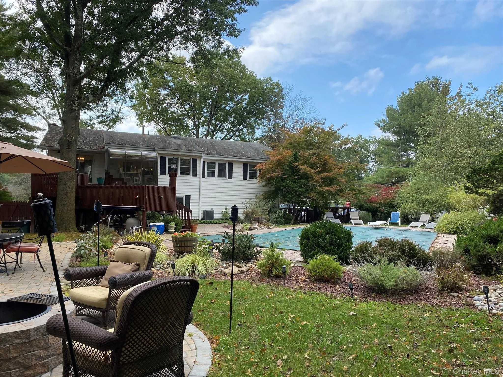 View of pool with a patio area and a lawn View of pool with a patio area and a lawn