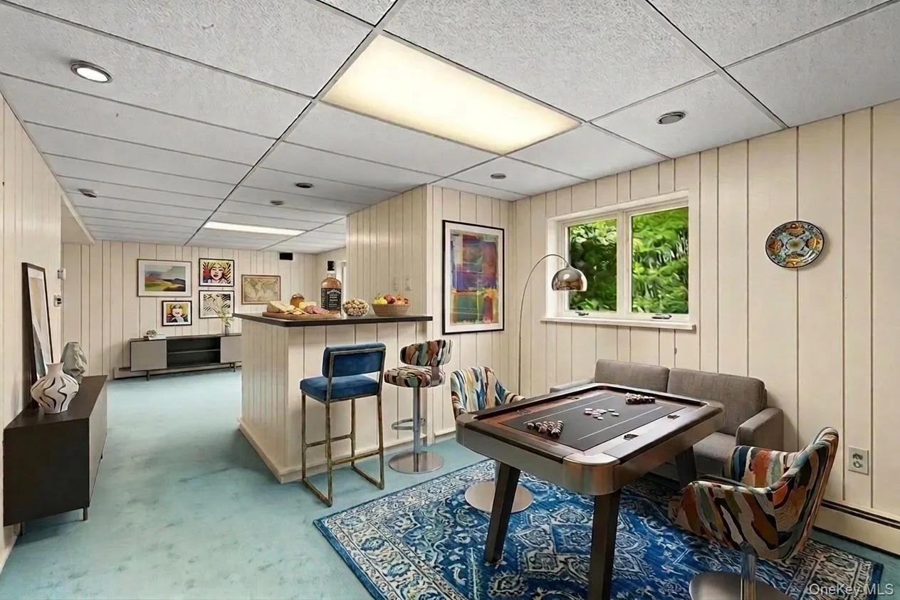 Virtually staged with lighter painted paneling and new furnishings Virtually staged with lighter painted paneling and new furnishings