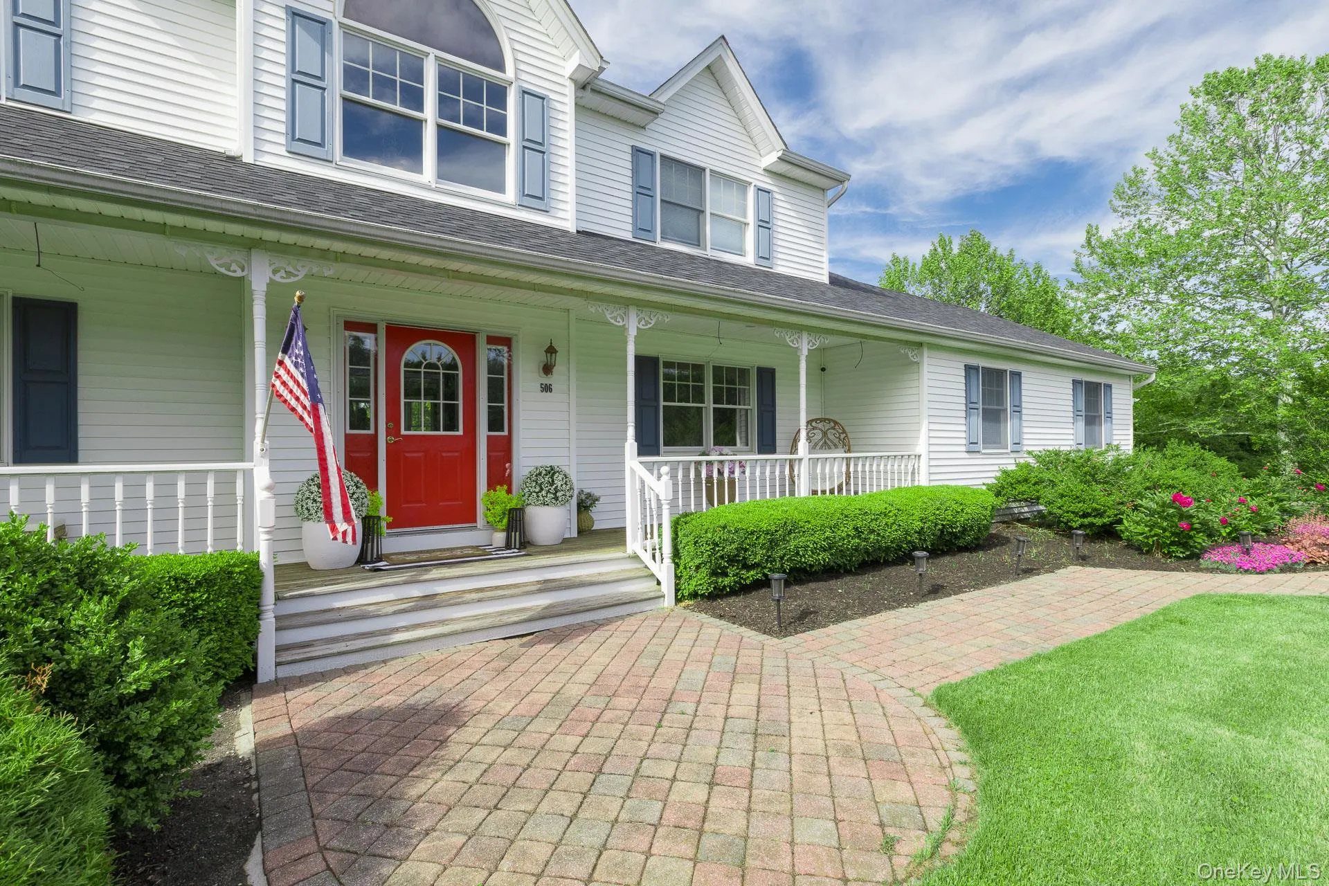 Beautiful stone-paved walkway leading to a charming covered wraparound porch. Beautiful stone-paved walkway leading to a charming covered wraparound porch.