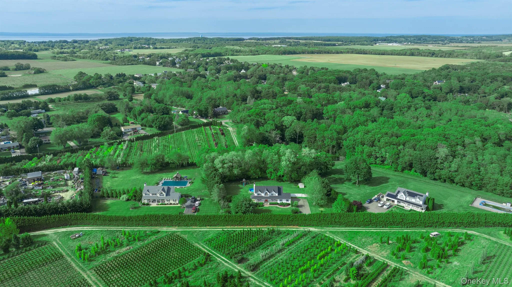 Aerial view emphasizing the incredible boundary of mature trees and premium privacy, all situated in a prime Baiting Hollow location under 2 miles to the Long Island Sound Aerial view emphasizing the incredible boundary of mature trees and premium privacy, all situated in a prime Baiting Hollow location under 2 miles to the Long Island Sound