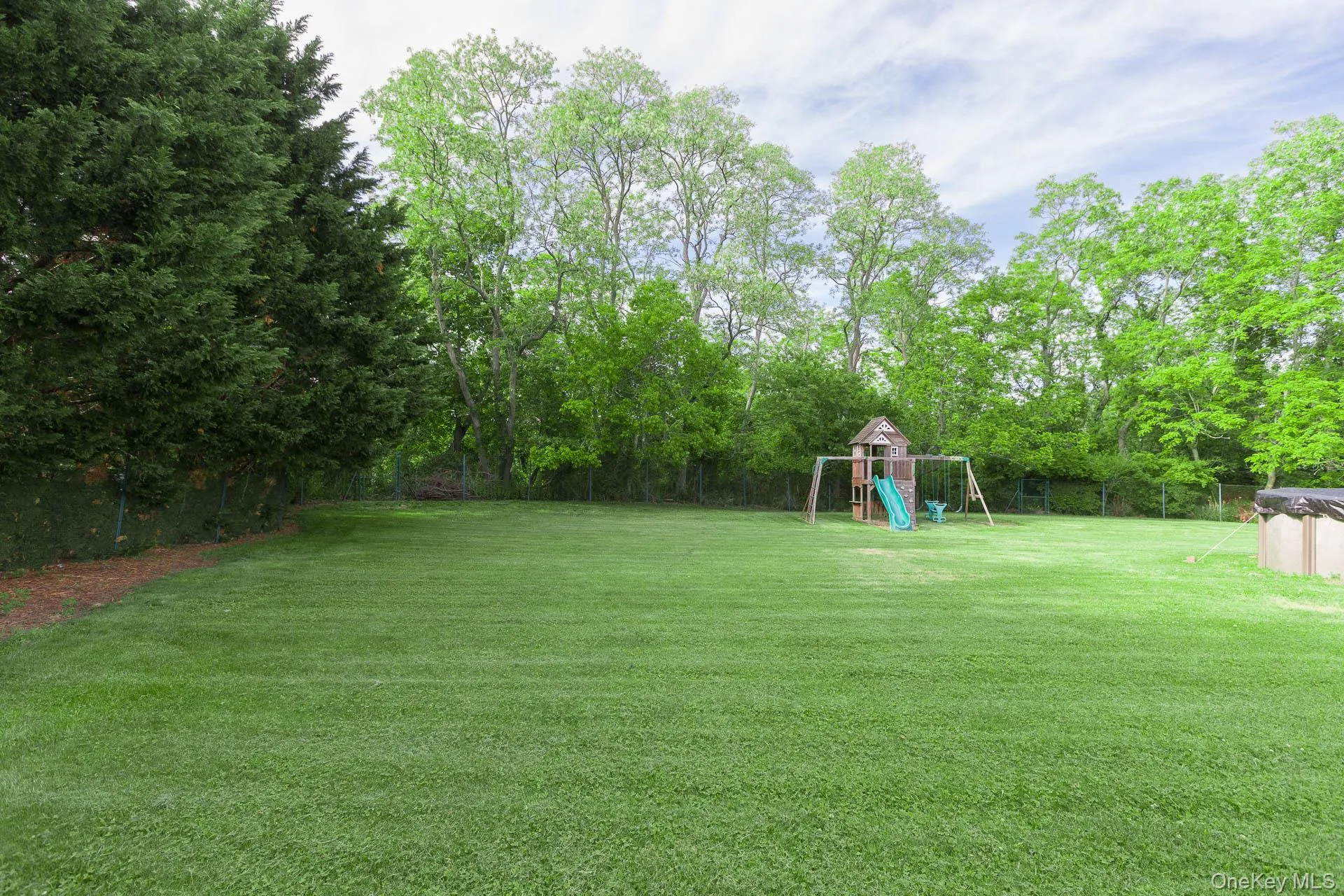 Expansive green lawn with mature perimeter trees Expansive green lawn with mature perimeter trees