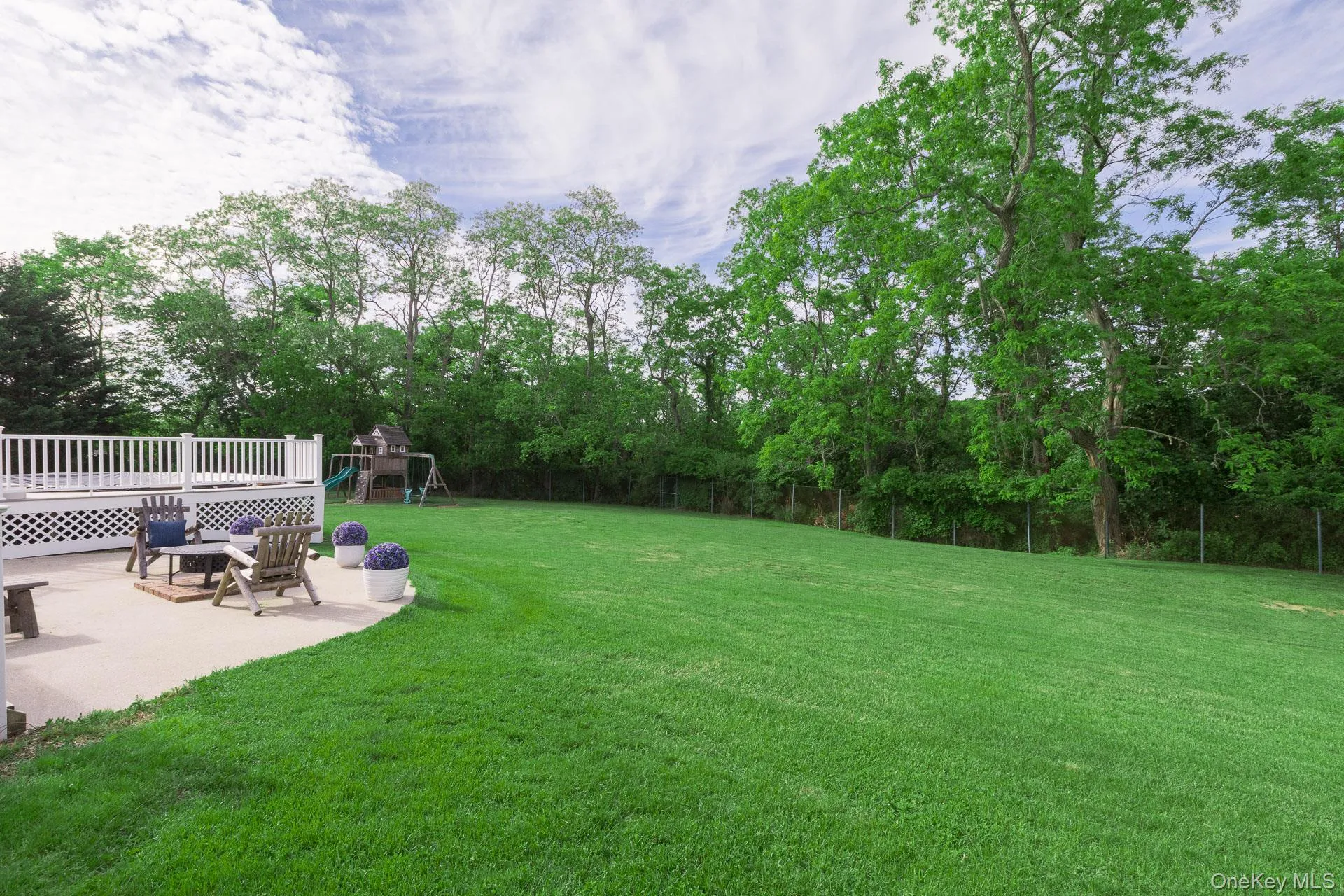 Expansive green lawn providing abundant outdoor area Expansive green lawn providing abundant outdoor area
