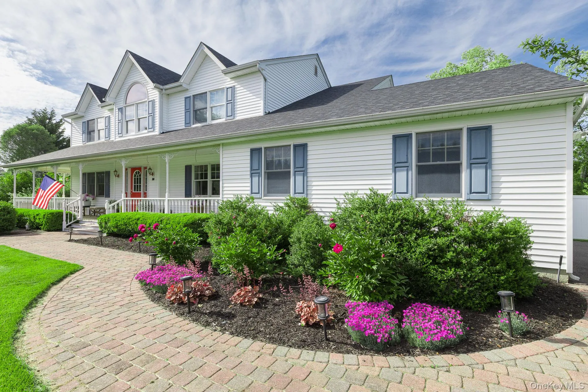 A beautiful stone-paved walkway and lovely landscaping welcome you home to this classic Colonial-style residence. Boasting a brand-new 40-year architectural roof, crisp white siding, an attached two-car garage, an extra-wide driveway, and a spacious full-width wraparound covered porch A beautiful stone-paved walkway and lovely landscaping welcome you home to this classic Colonial-style residence. Boasting a brand-new 40-year architectural roof, crisp white siding, an attached two-car garage, an extra-wide driveway, and a spacious full-width wraparound covered porch