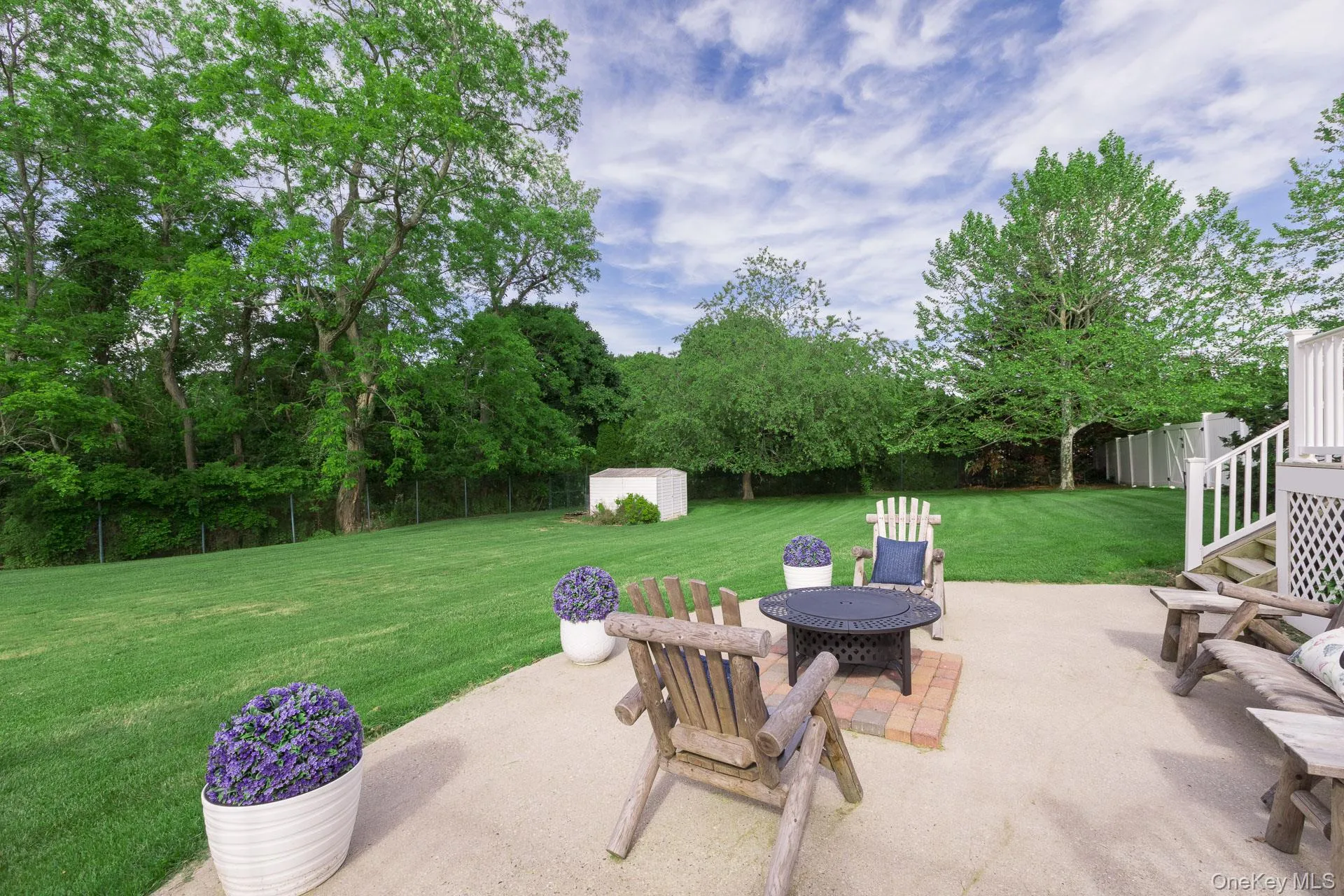 Expansive concrete patio offering ample outdoor space Expansive concrete patio offering ample outdoor space