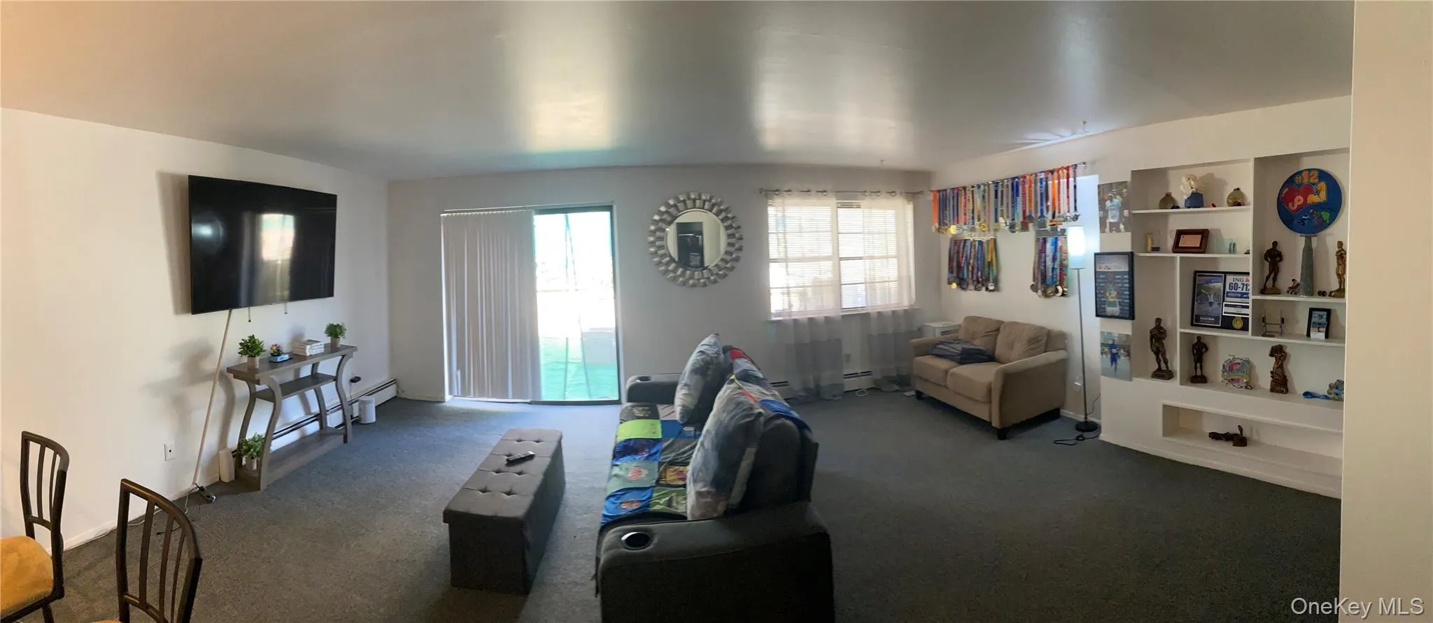 Living room featuring carpet floors and built in features Living room featuring carpet floors and built in features