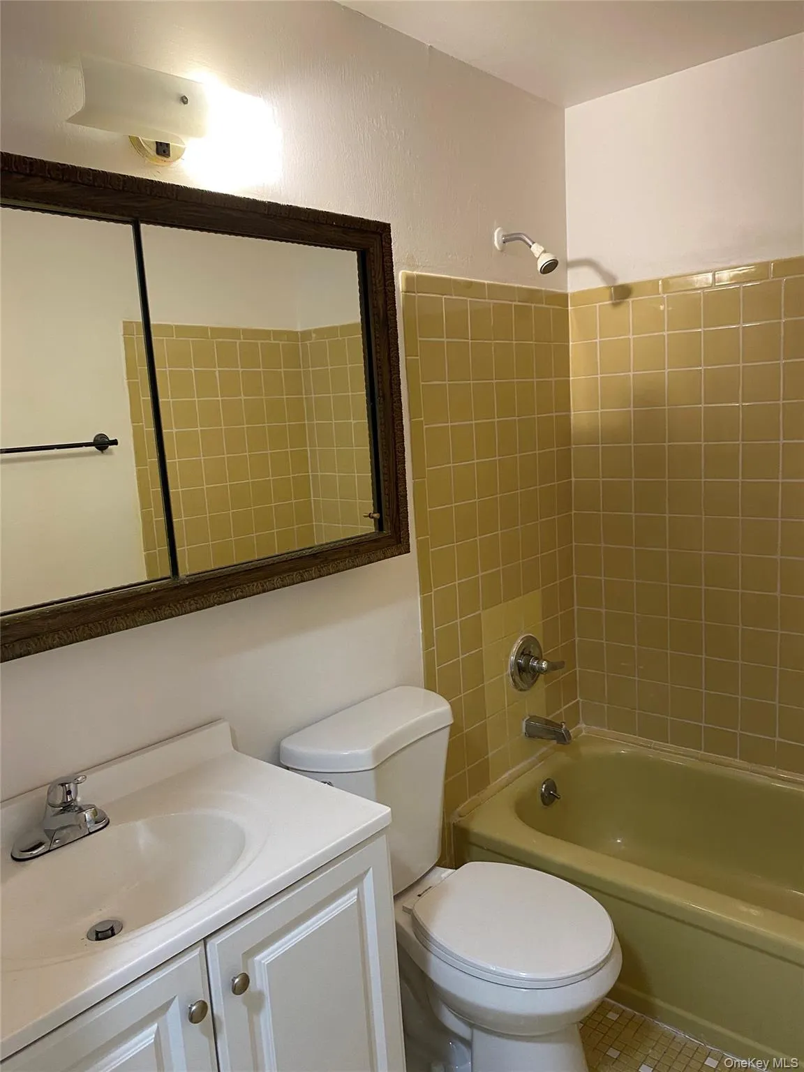 Bathroom featuring vanity, toilet, shower / washtub combination, and tile patterned floors Bathroom featuring vanity, toilet, shower / washtub combination, and tile patterned floors
