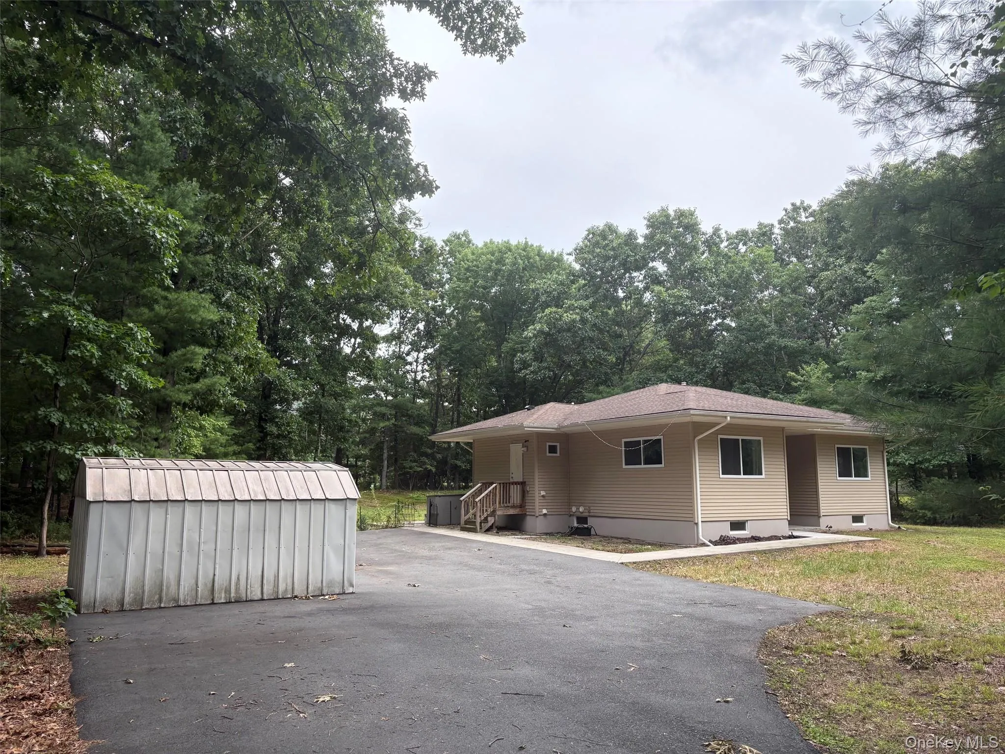 this is a view from the driveway showing the shed and the side entrance to the house and the front entrance this is a view from the driveway showing the shed and the side entrance to the house and the front entrance
