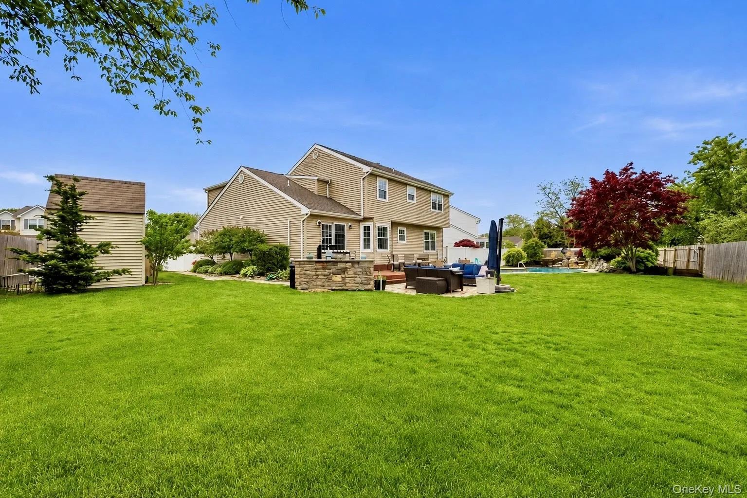 Expansive green lawn providing ample outdoor space Expansive green lawn providing ample outdoor space