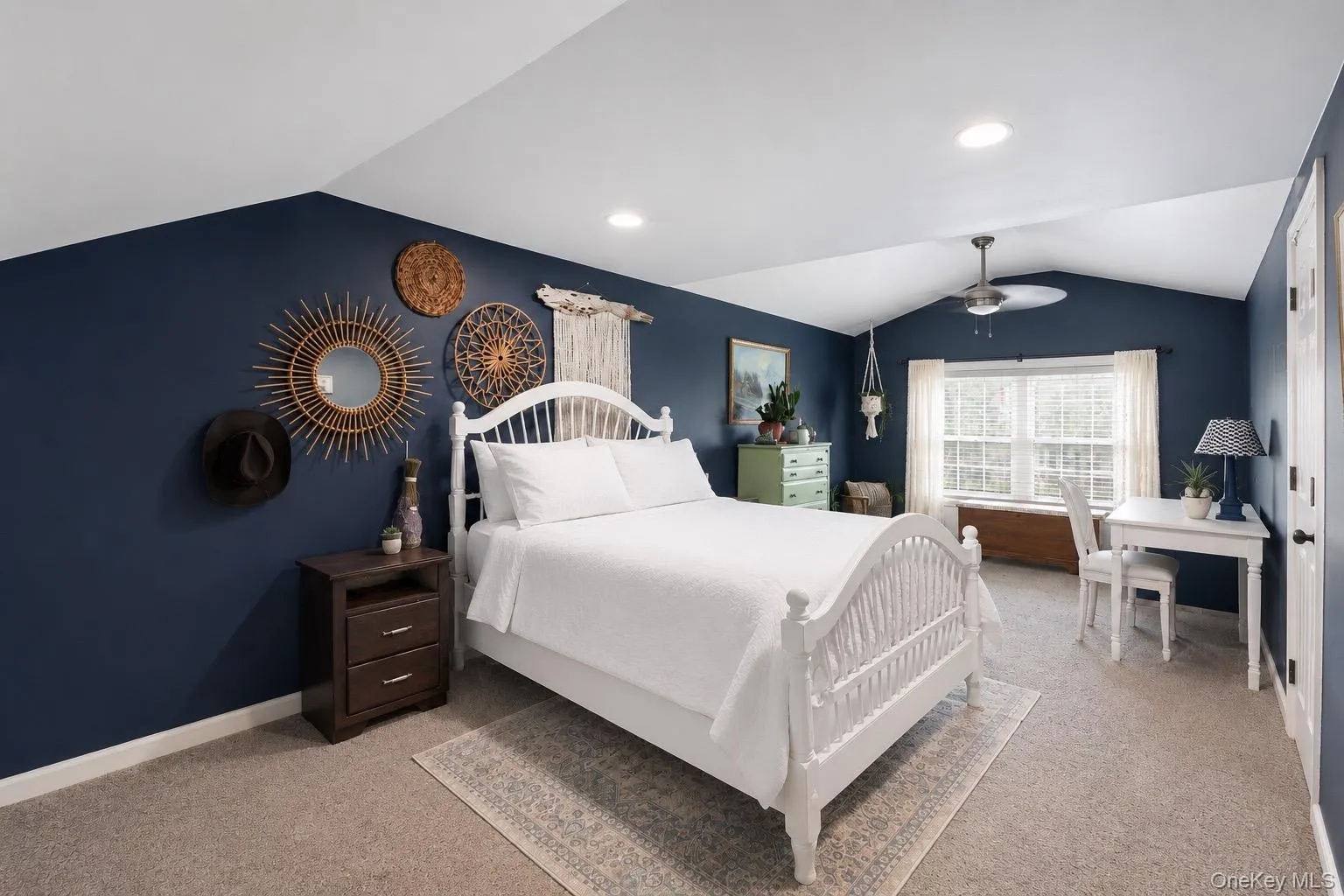 Spacious room featuring vaulted ceilings, recessed lighting, and a ceiling fan Spacious room featuring vaulted ceilings, recessed lighting, and a ceiling fan