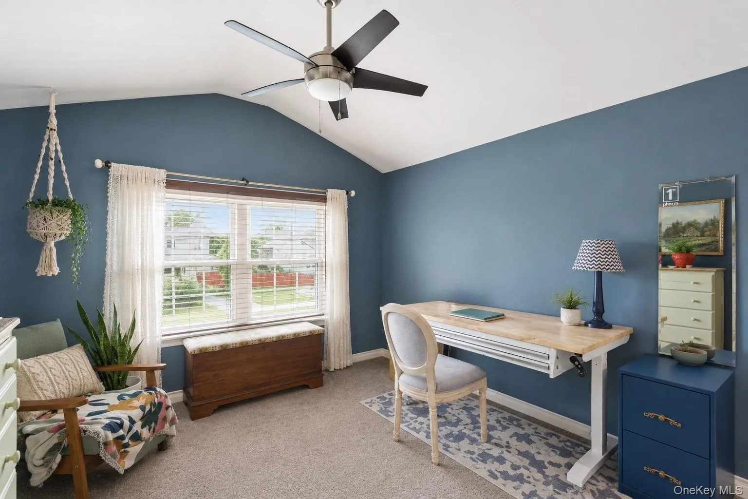 Room featuring a vaulted ceiling and a contemporary ceiling fan Room featuring a vaulted ceiling and a contemporary ceiling fan