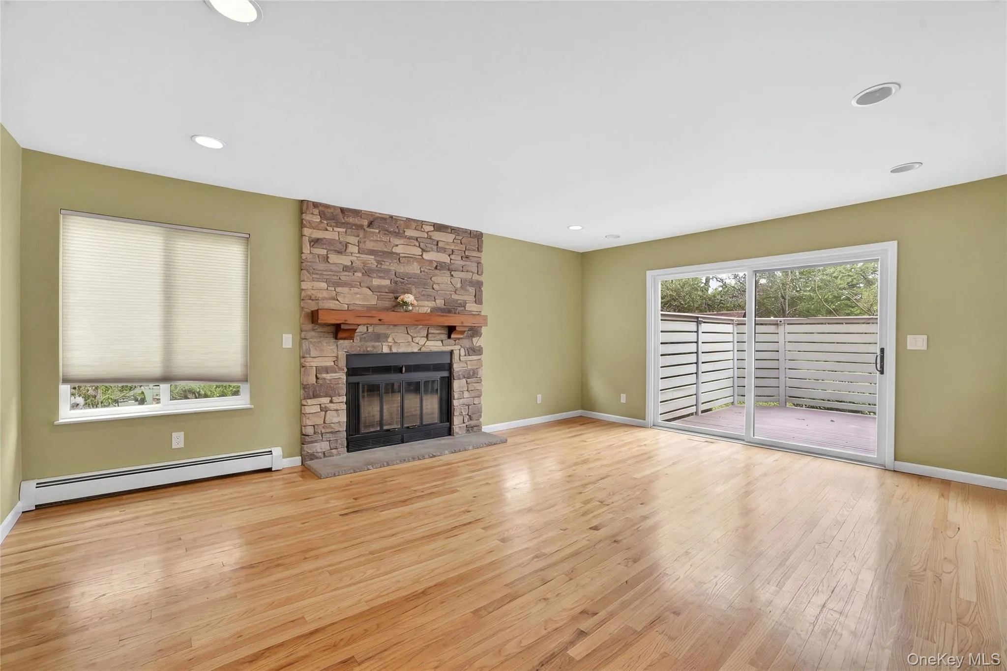 Inviting Family Room with Stone surround Fireplace and SGD to Deck and Yard Inviting Family Room with Stone surround Fireplace and SGD to Deck and Yard