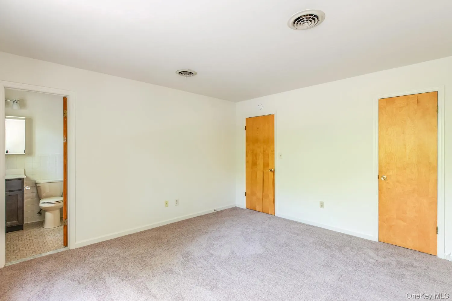 Walk-in closet, view into Primary Bath Walk-in closet, view into Primary Bath