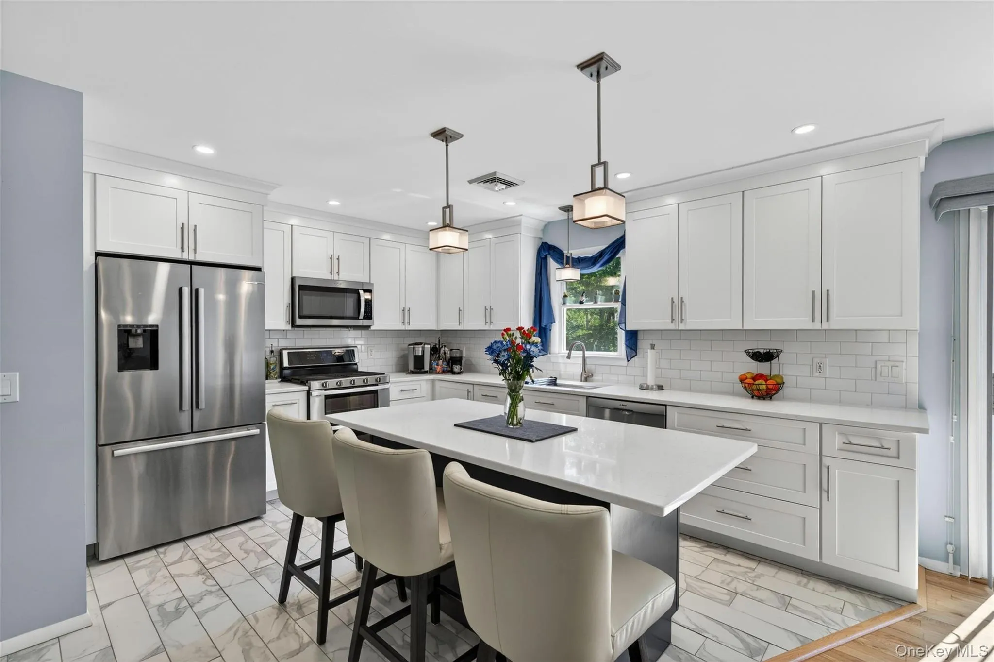 Designer lighting and marshmallow glazed cabinets with crown molding. Designer lighting and marshmallow glazed cabinets with crown molding.