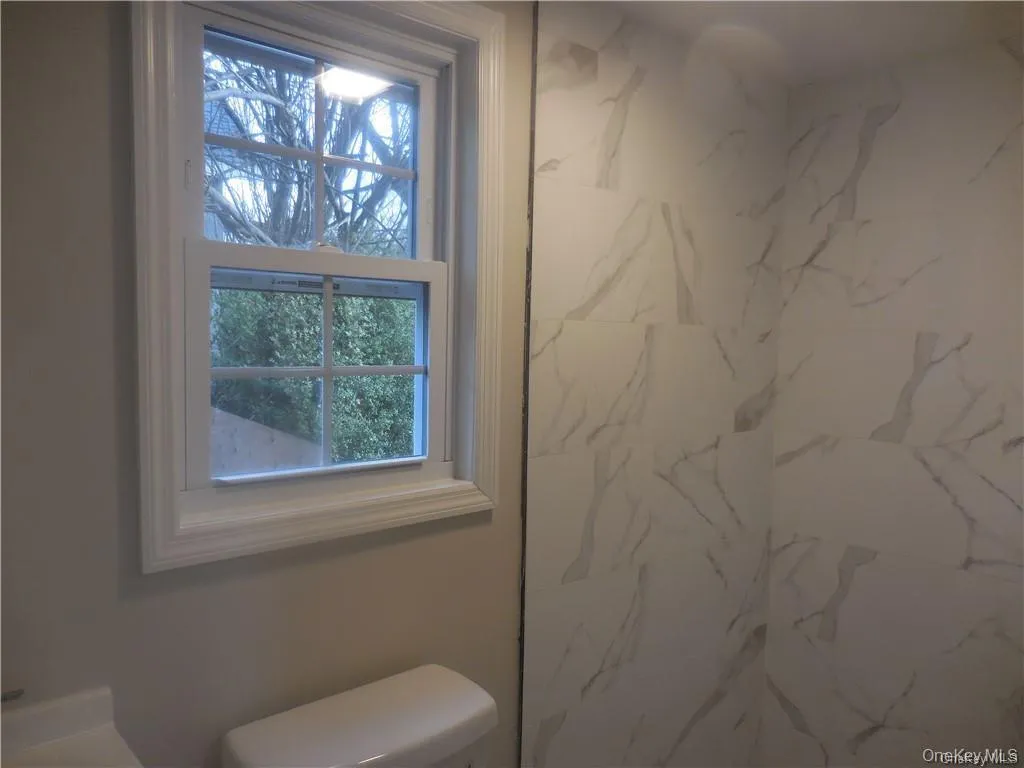 View of the bathroom with the window. View of the bathroom with the window.
